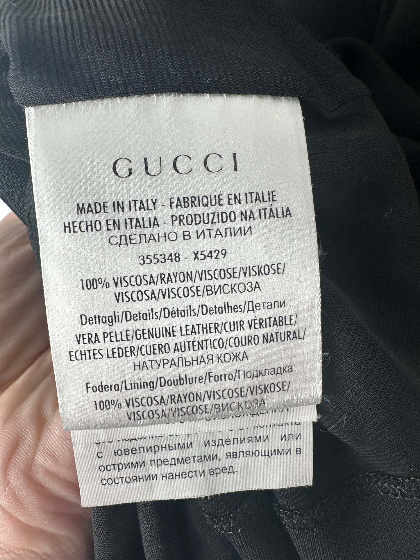 Gucci label on a garment with text and product details.