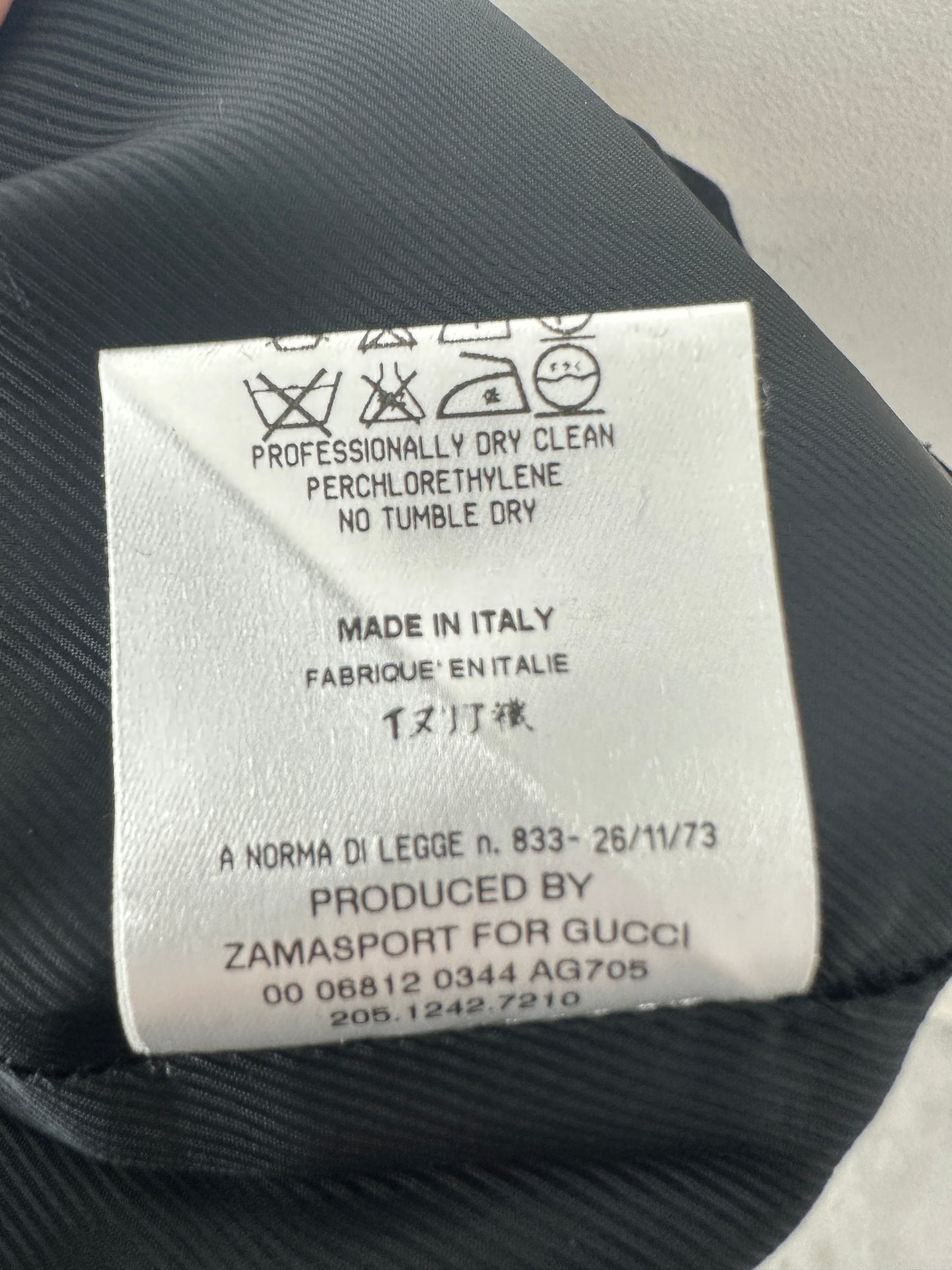 Clothing label on a black fabric background