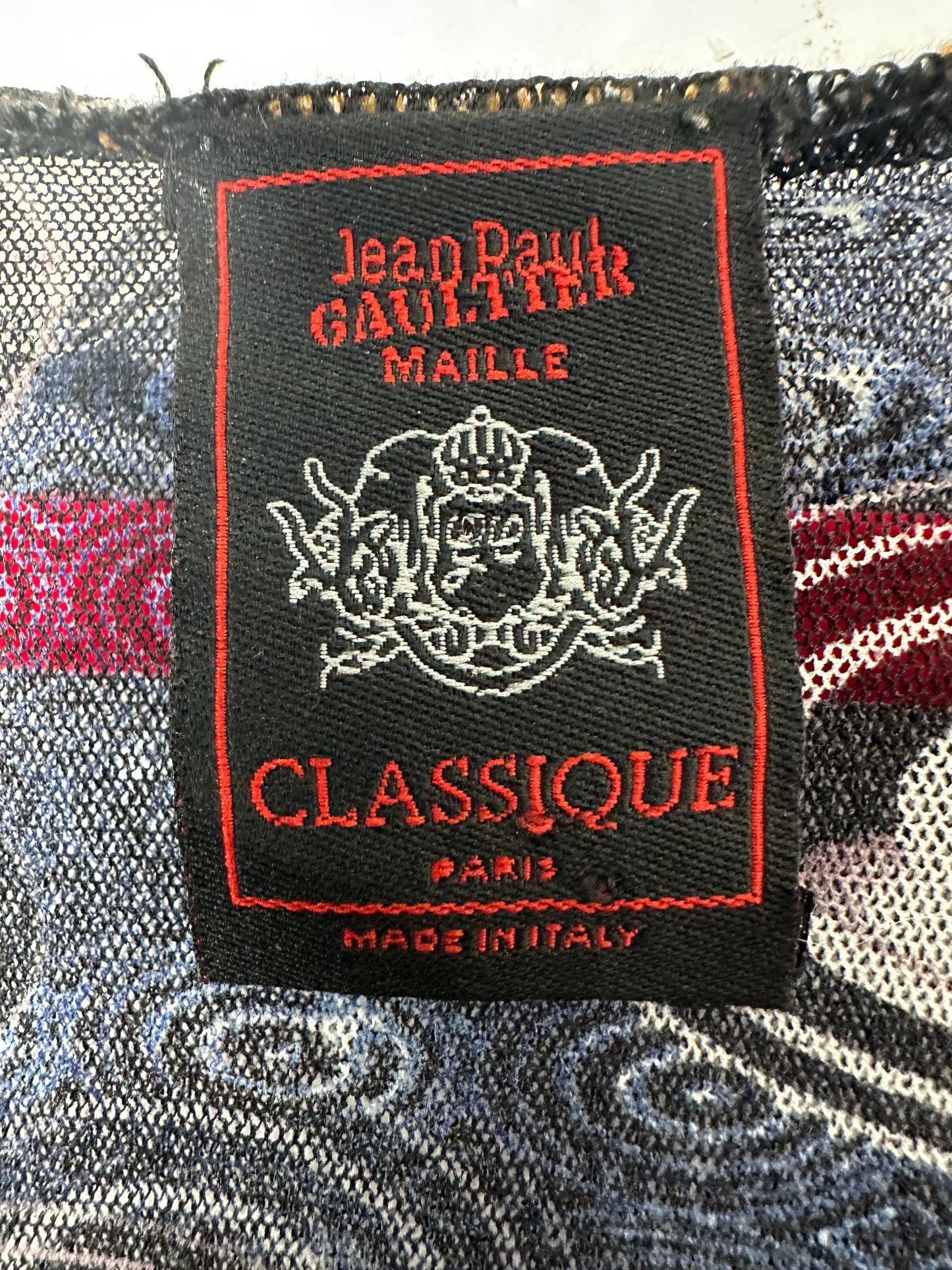 Jean Paul Gaultier Classique label on a patterned fabric background