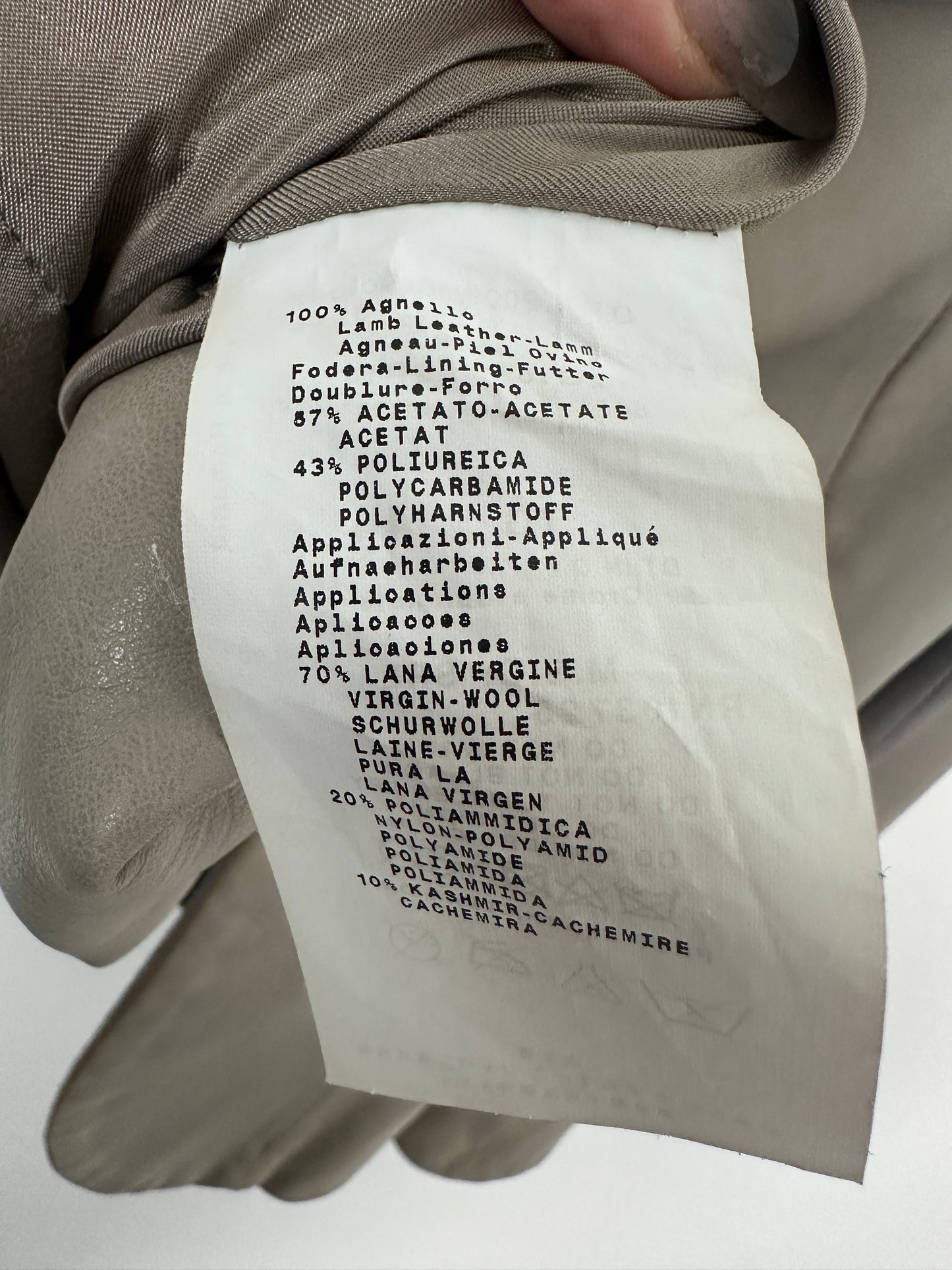 Close-up of a fabric label on a garment with text.