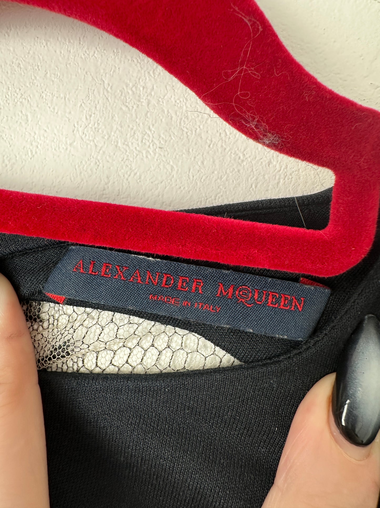 Close-up of a dress with 'Alexander McQueen' label
