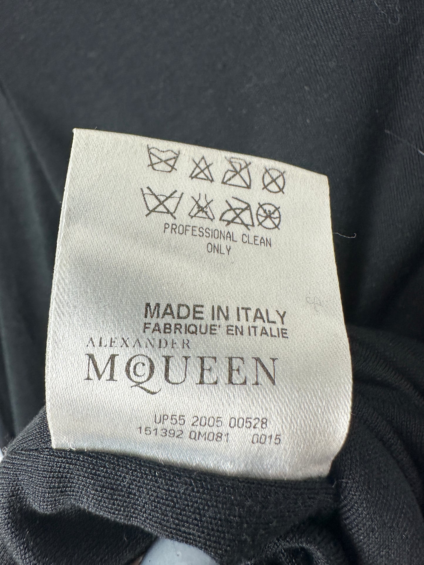 Alexander McQueen label on a garment with care instructions and brand name.