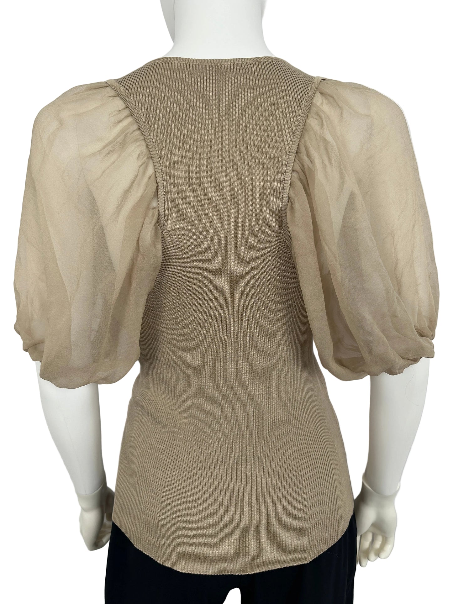 Mannequin wearing a beige outfit with a white background