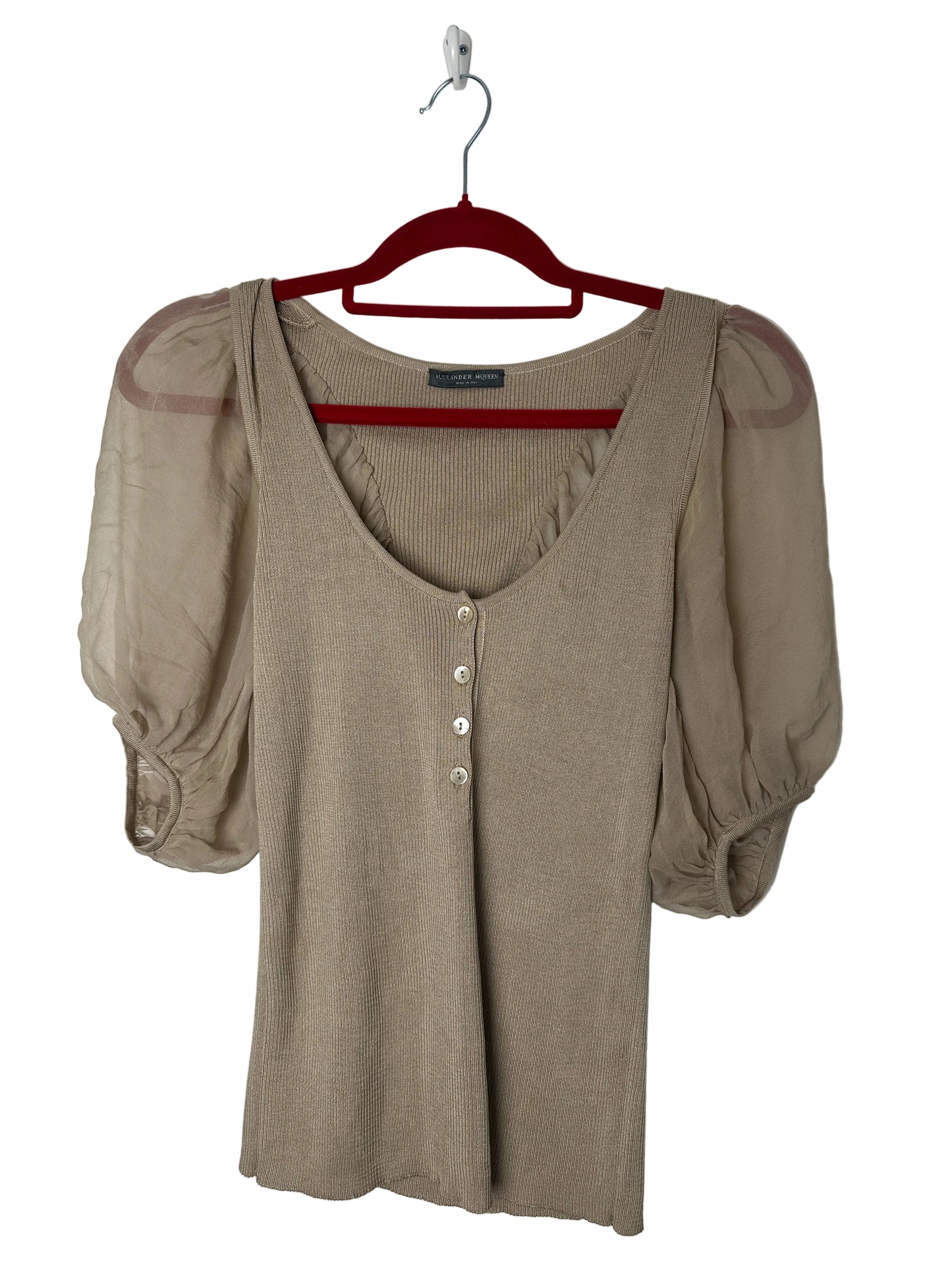 Beige puff-sleeve shirt on a red hanger against a white background