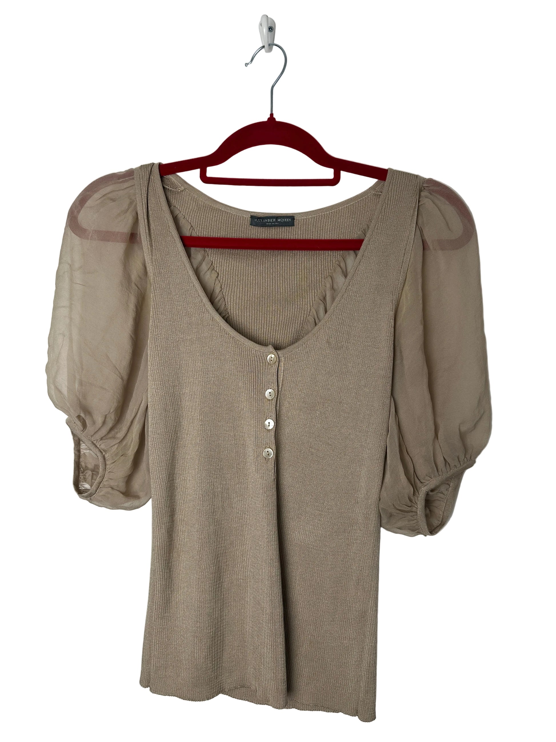 Beige puff-sleeve shirt on a red hanger against a white background