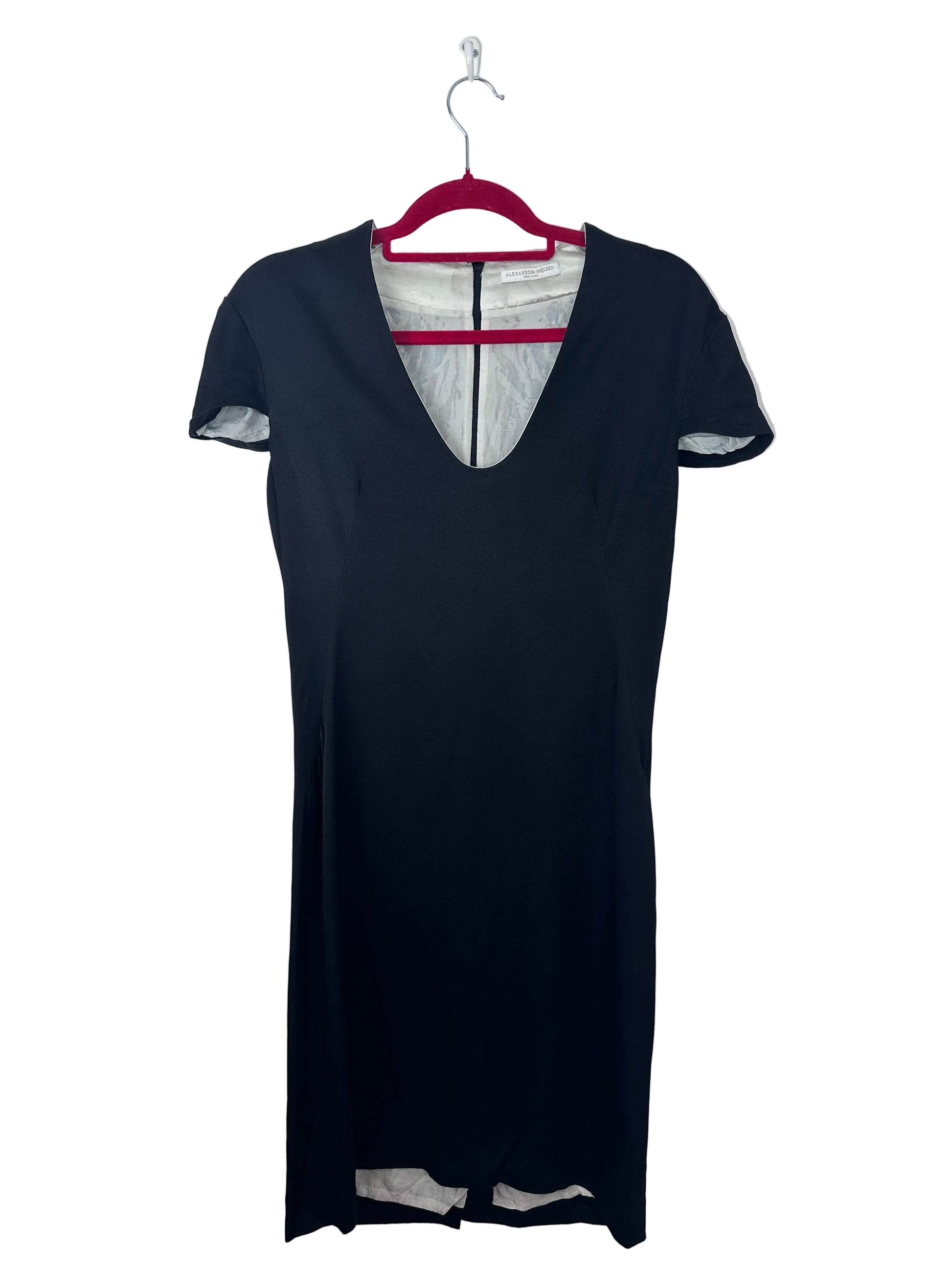 A black short-sleeve dress with a split V-neckline, hanging on a red hanger against a plain white background.