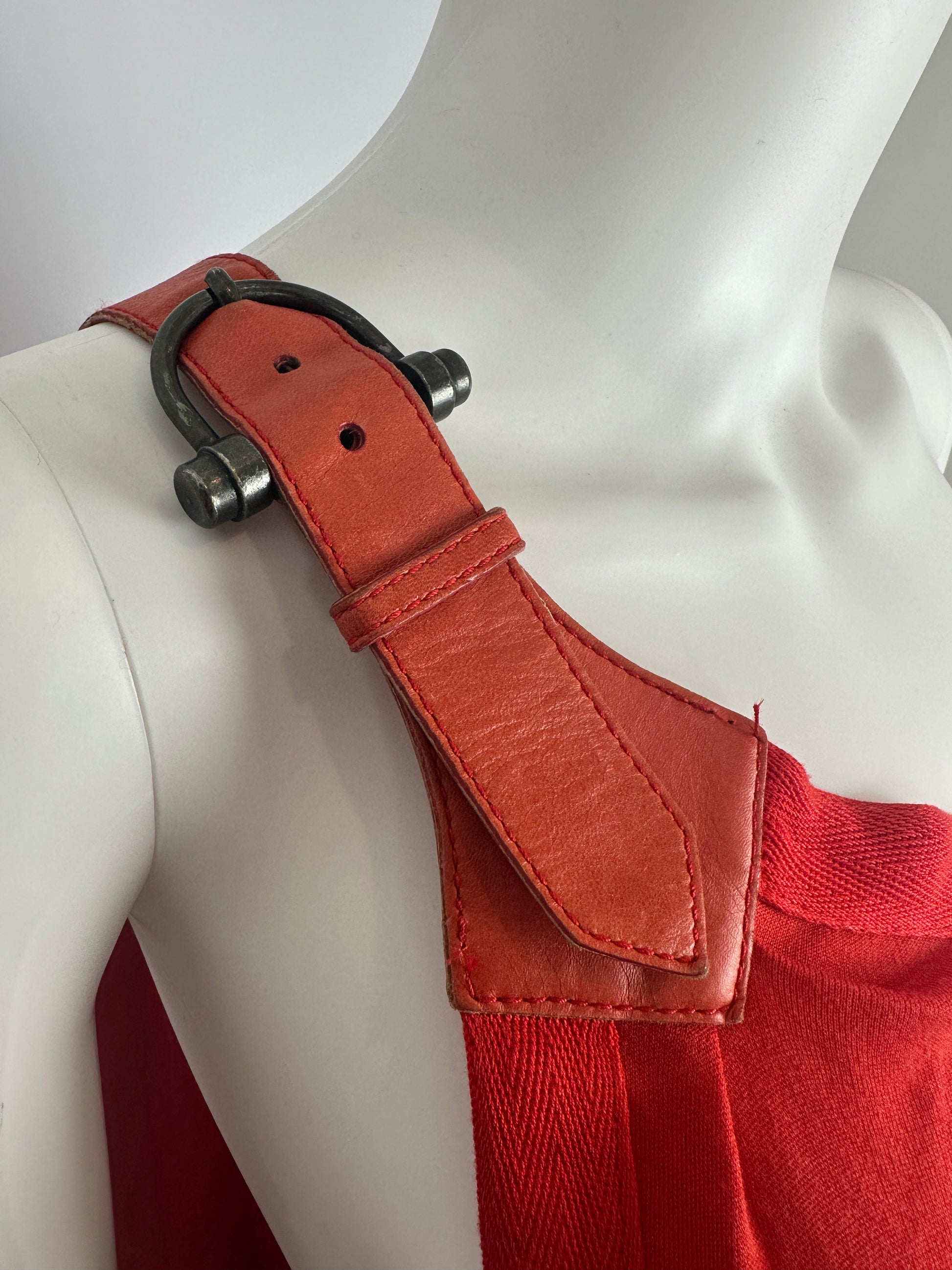 Red belt with a leather buckle on a mannequin