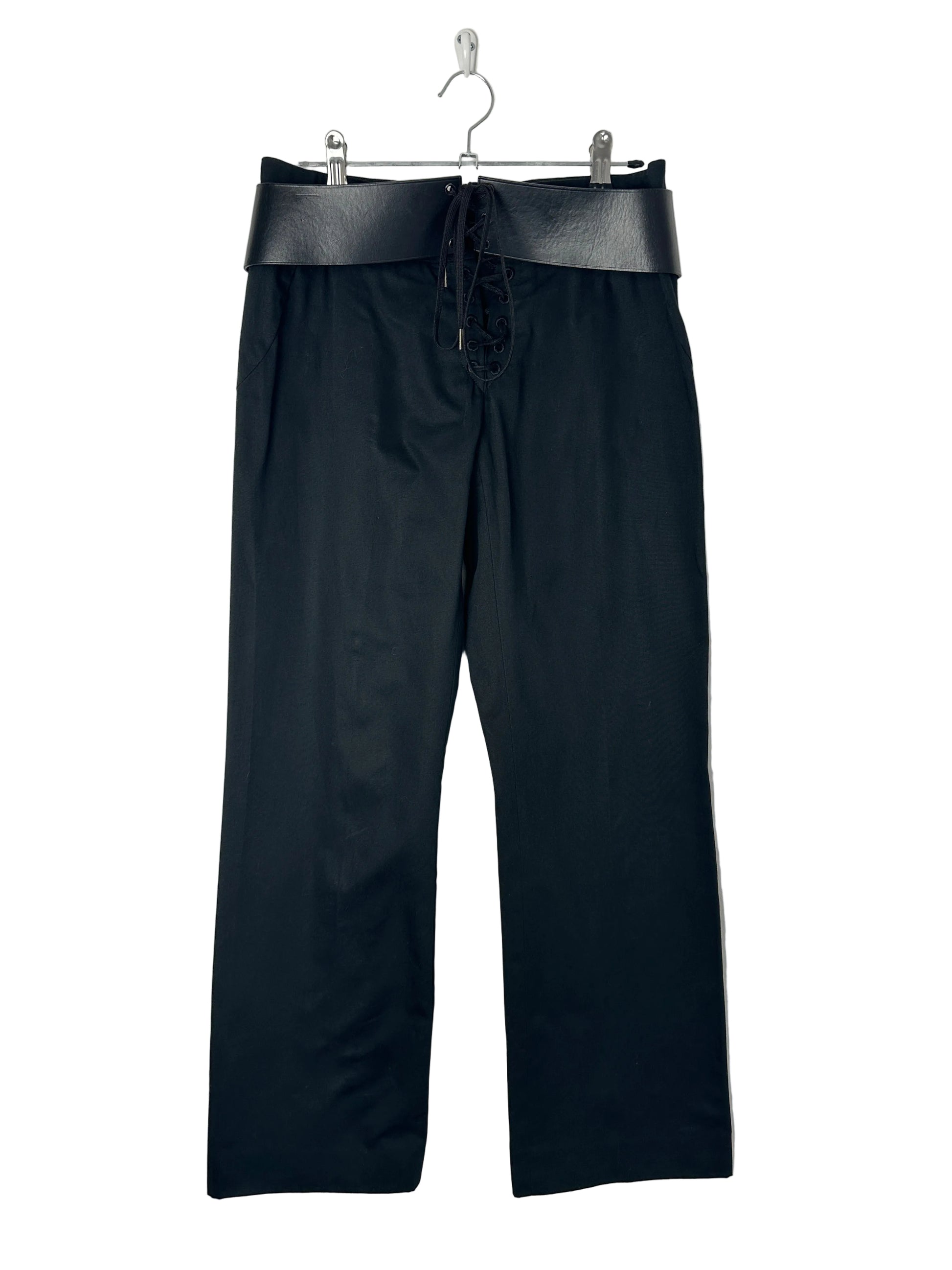Black pants on a hanger against a light gray background