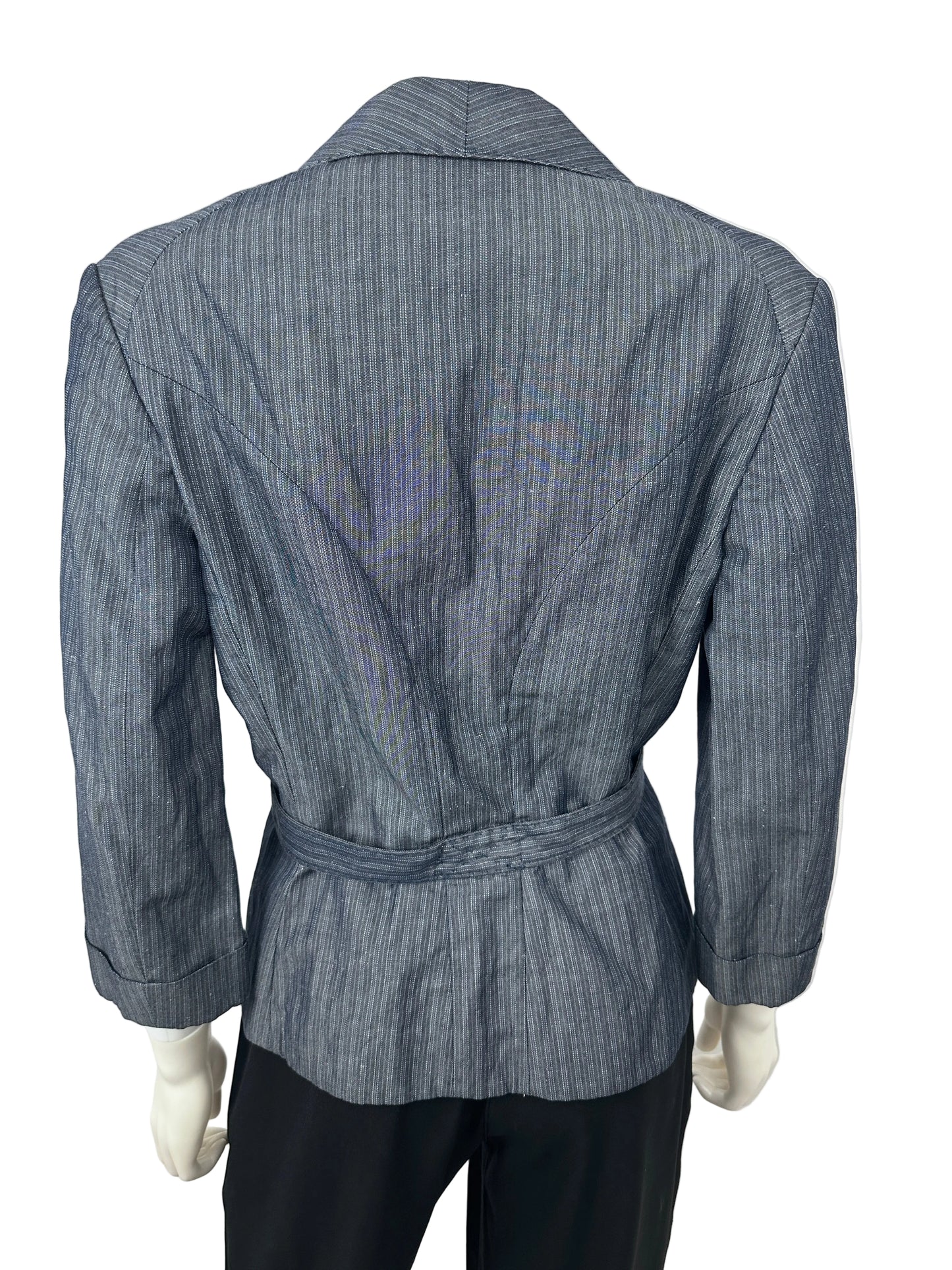A slate blue pinstriped belted jacket displayed on a mannequin, paired with black trousers, photographed against a plain white background.