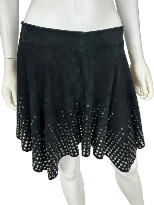 Black studded gloves on a mannequin arm against a gray background