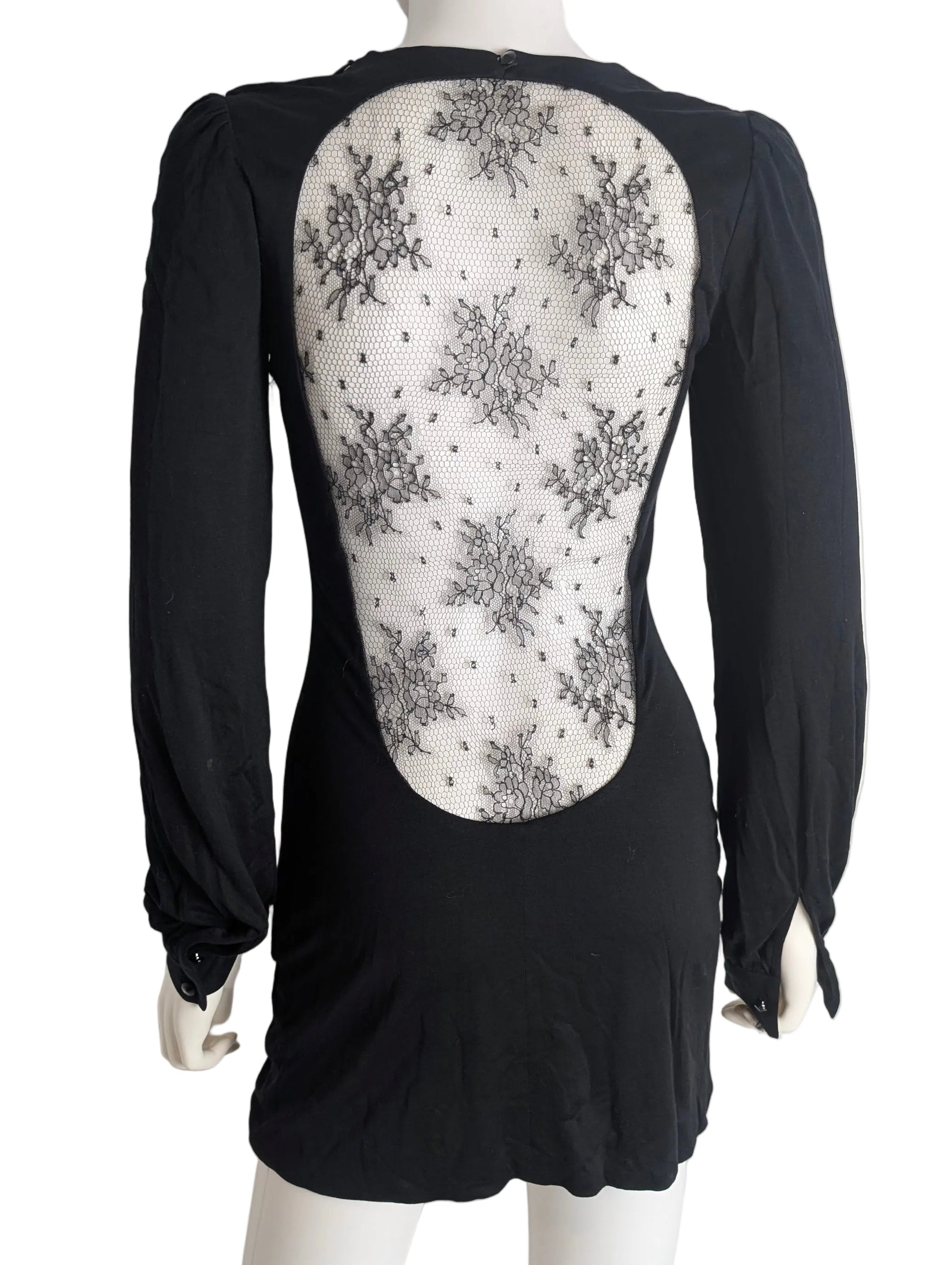 Black dress with floral pattern on the back worn by a mannequin against a white background