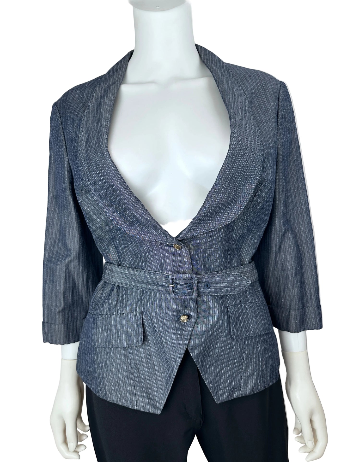 A blue-gray pinstriped wrap jacket with a belted waist and front pockets, displayed on a white mannequin torso with black trousers against a plain light background.