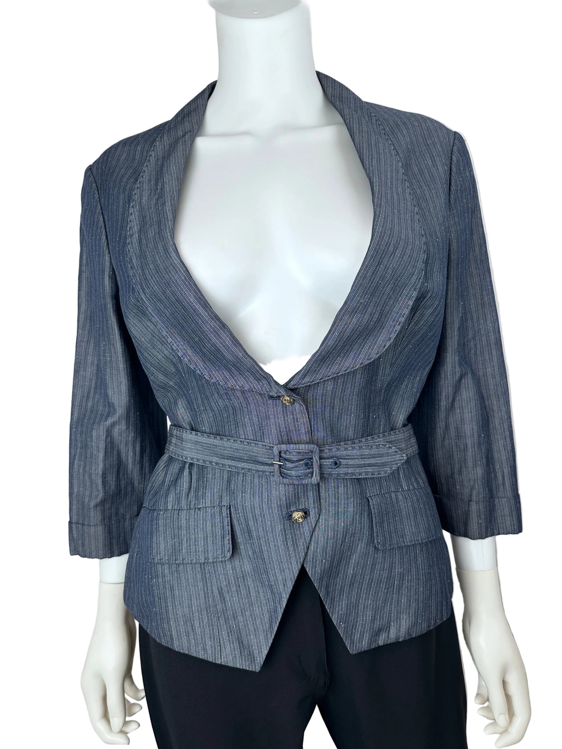 A blue-gray pinstriped wrap jacket with a belted waist and front pockets, displayed on a white mannequin torso with black trousers against a plain light background.