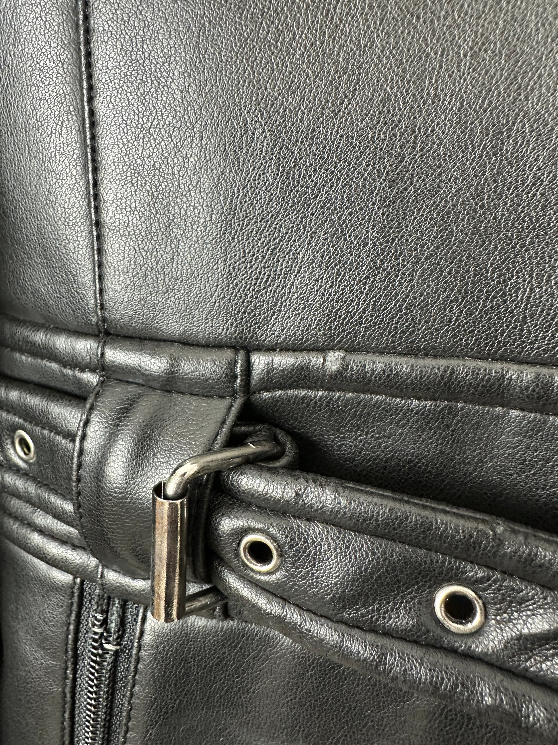 Close-up of a balck leather jacket with a buckle detail