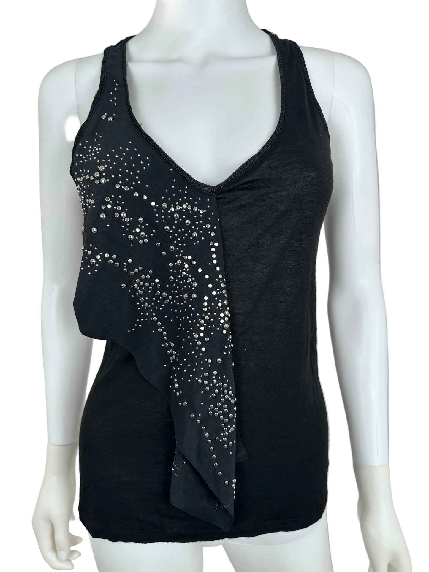 Black top with stud details on a mannequin against a neutral background