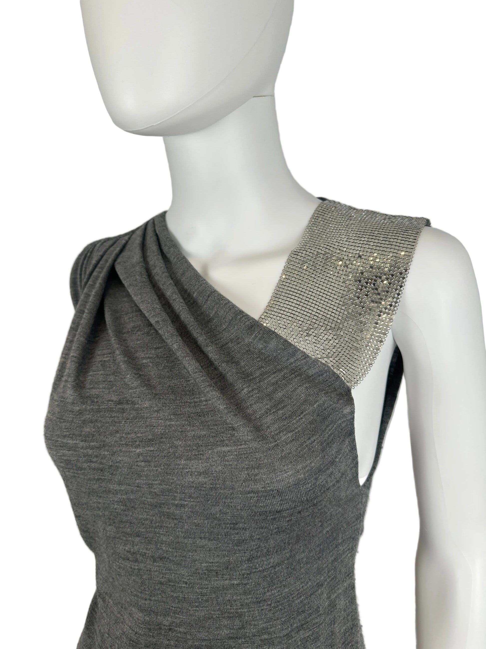 Mannequin wearing a gray top with a sparkly silver headband on a plain background