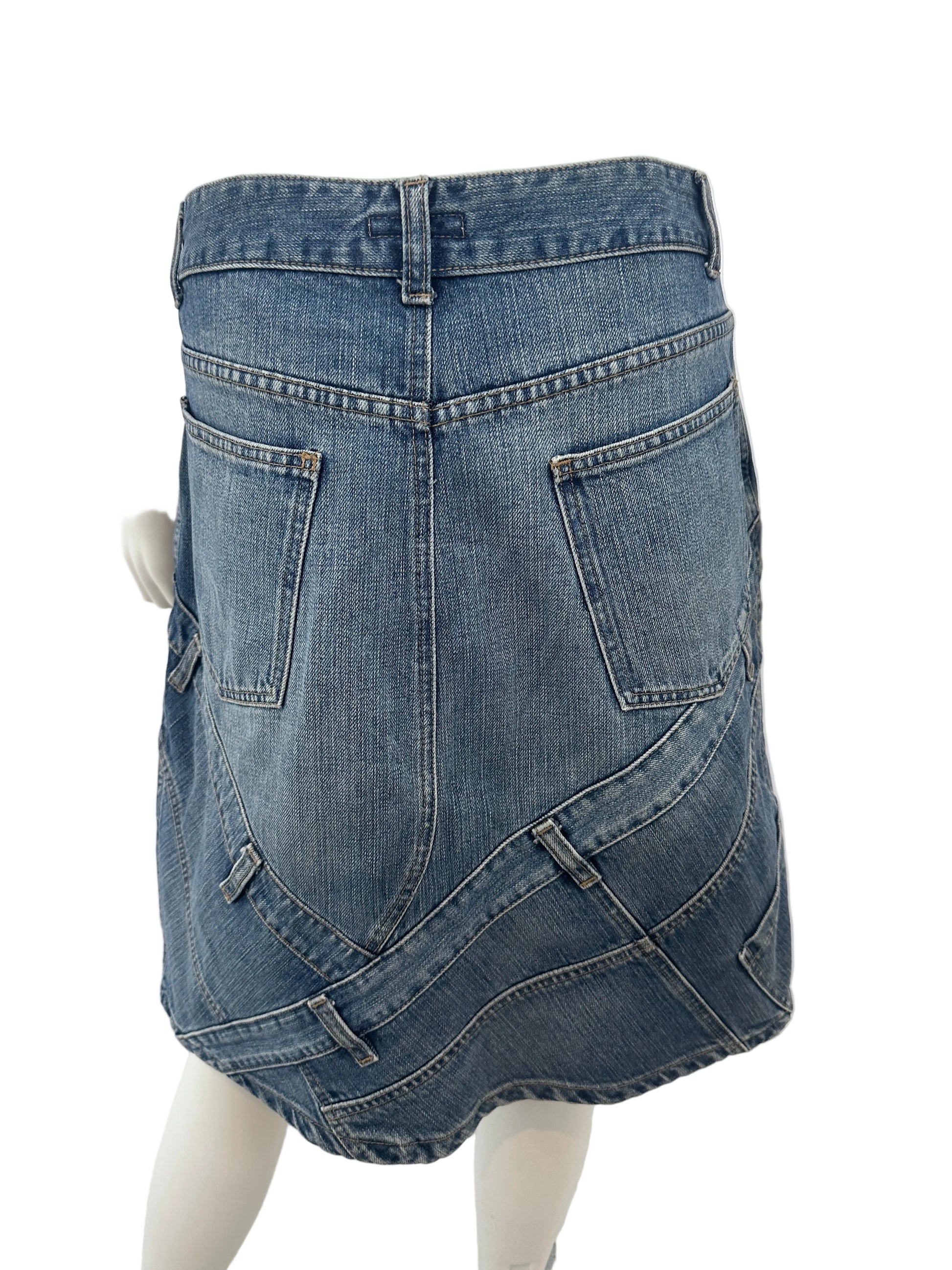 A pair of blue denim jeans shown from the back, displayed on a white mannequin torso against a white indoor background.