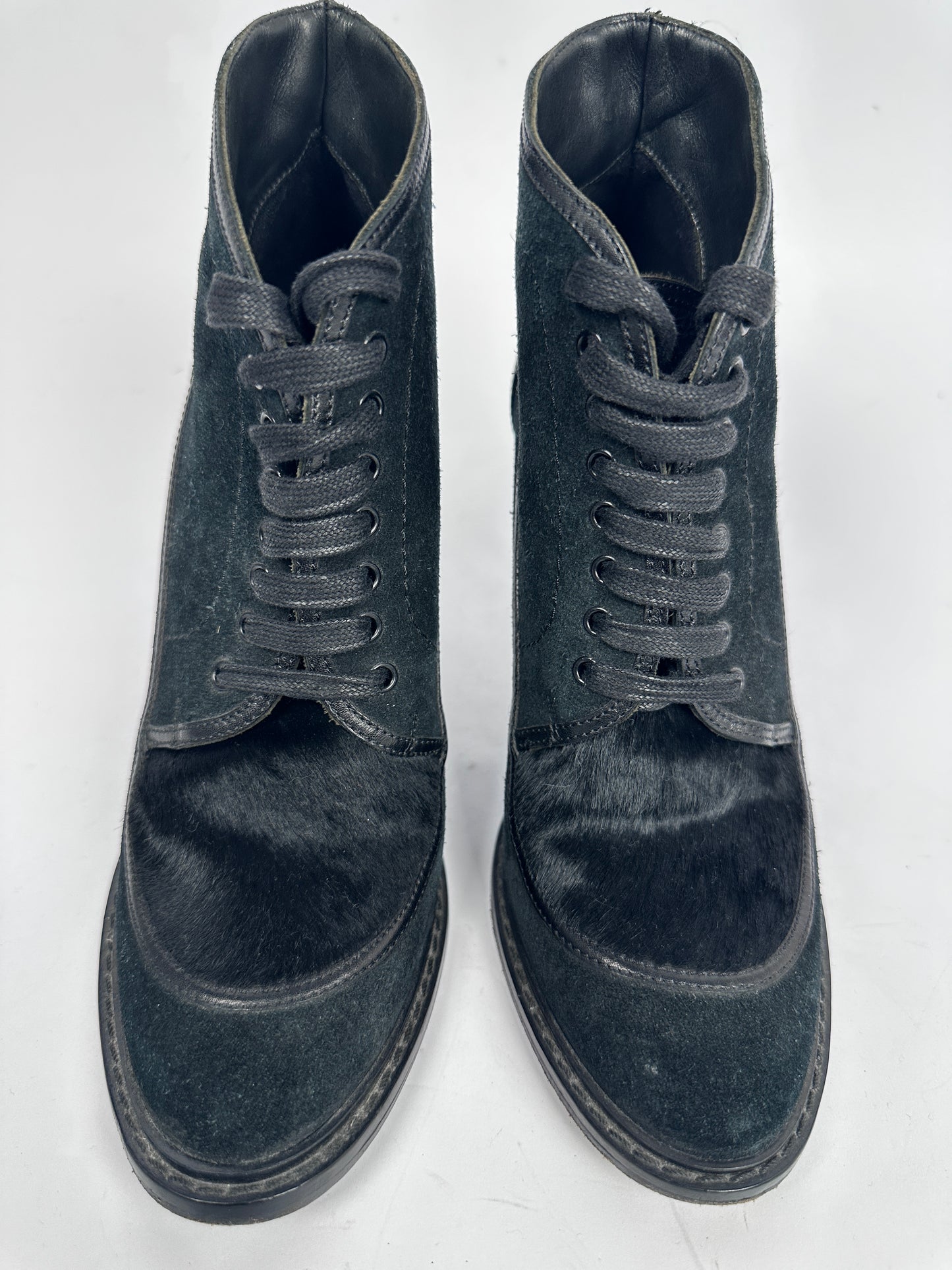 Pair of black suede boots on a white background