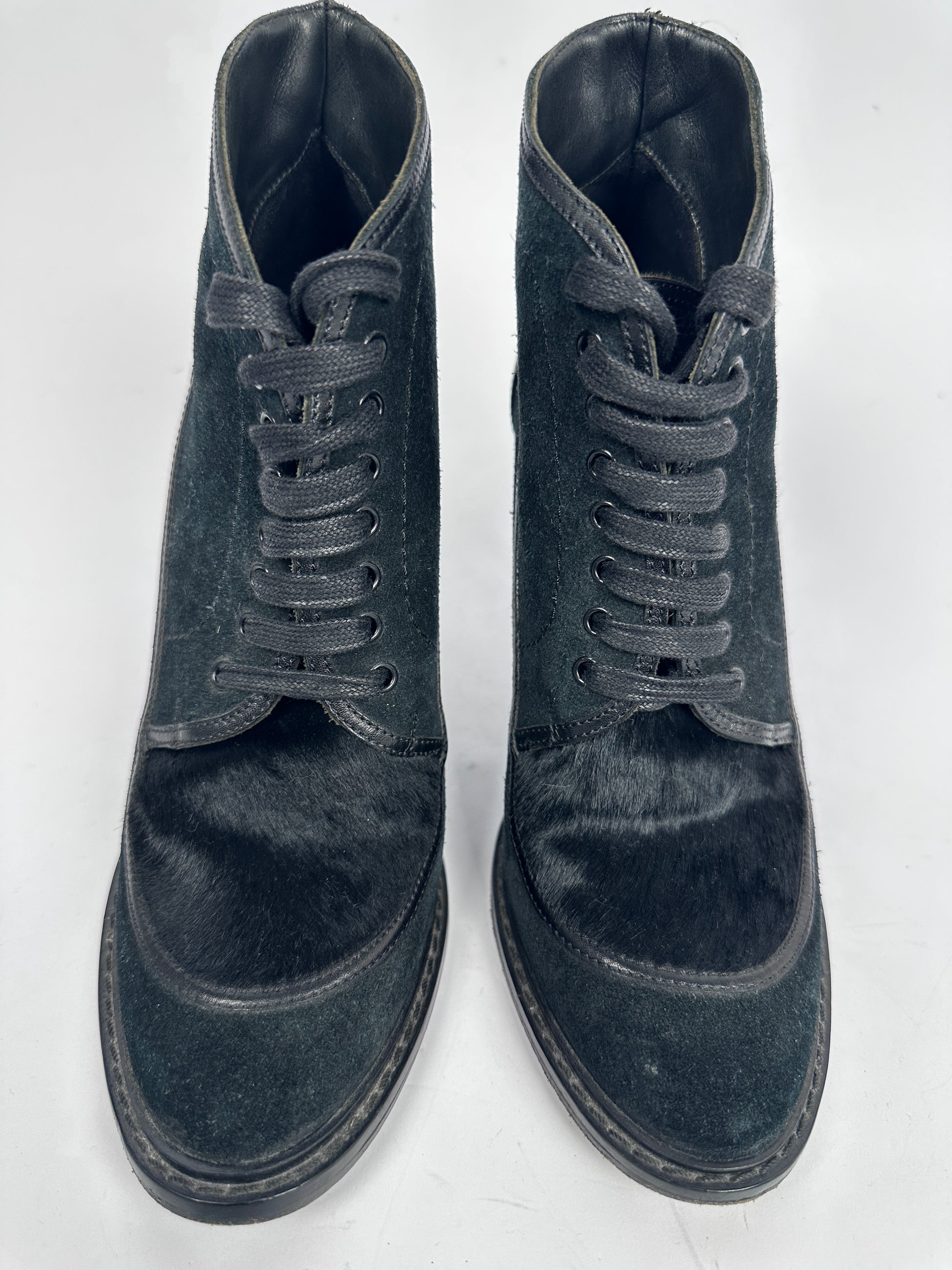 Pair of black suede boots on a white background