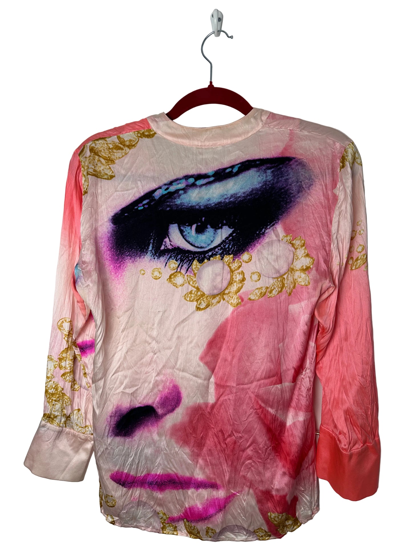 Pink top with gold accents and a purple design on a white background