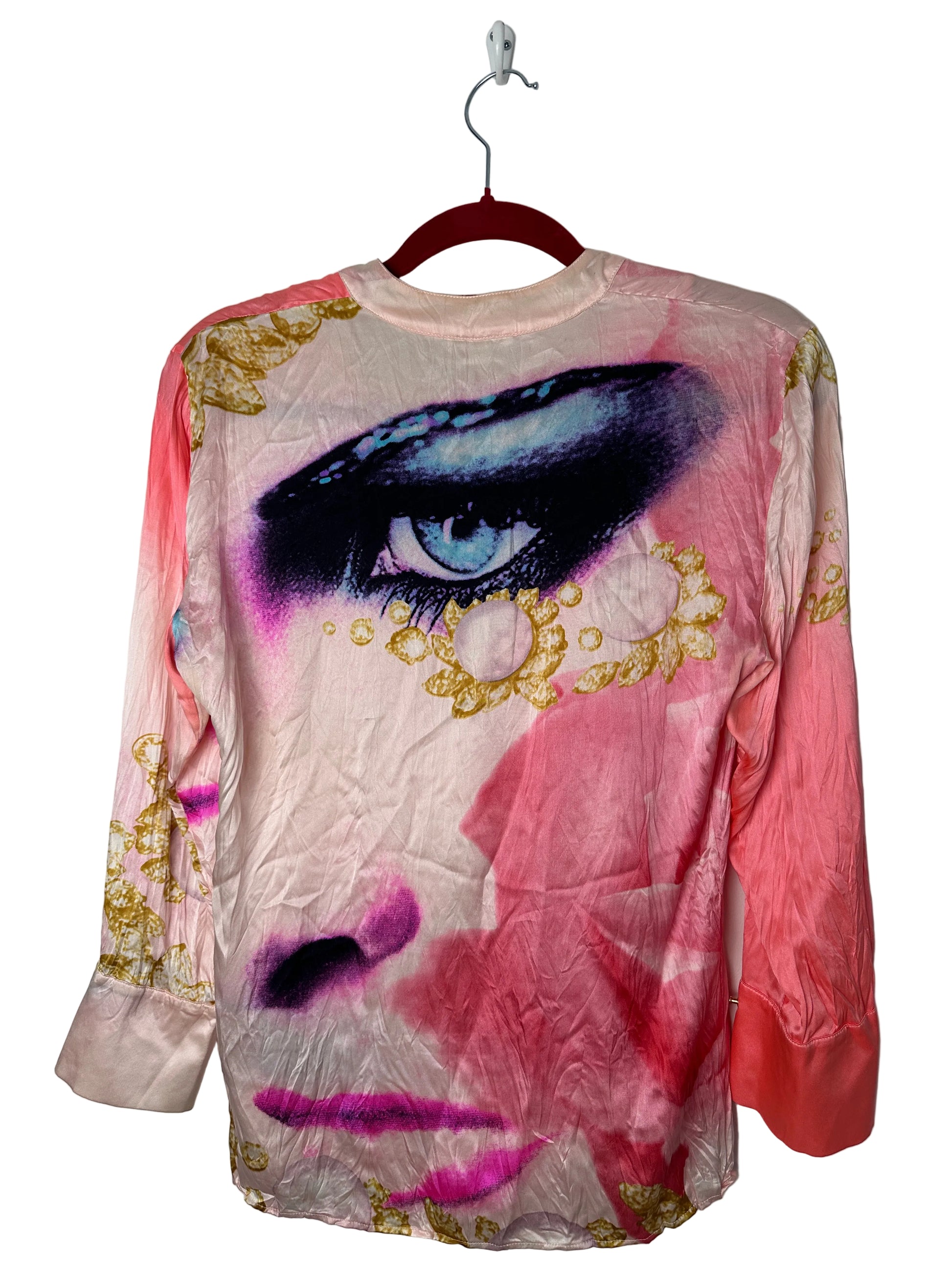 Pink top with gold accents and a purple design on a white background