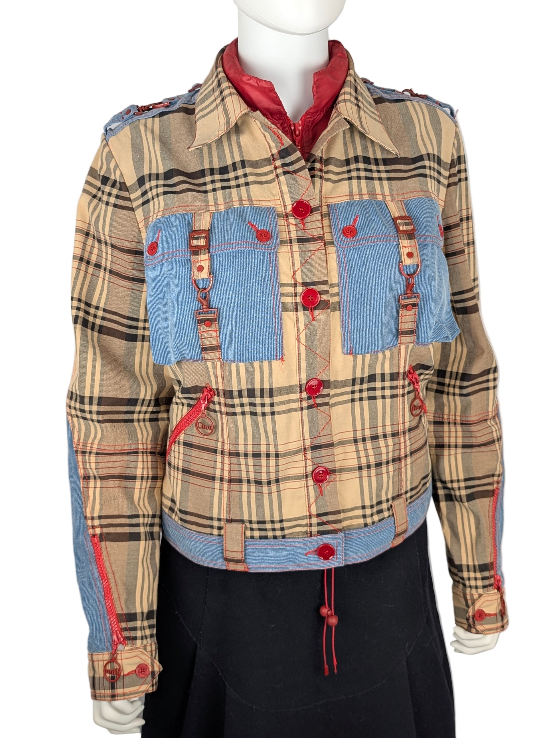 Plaid jacket with blue patches and red buttons on a mannequin against a white background