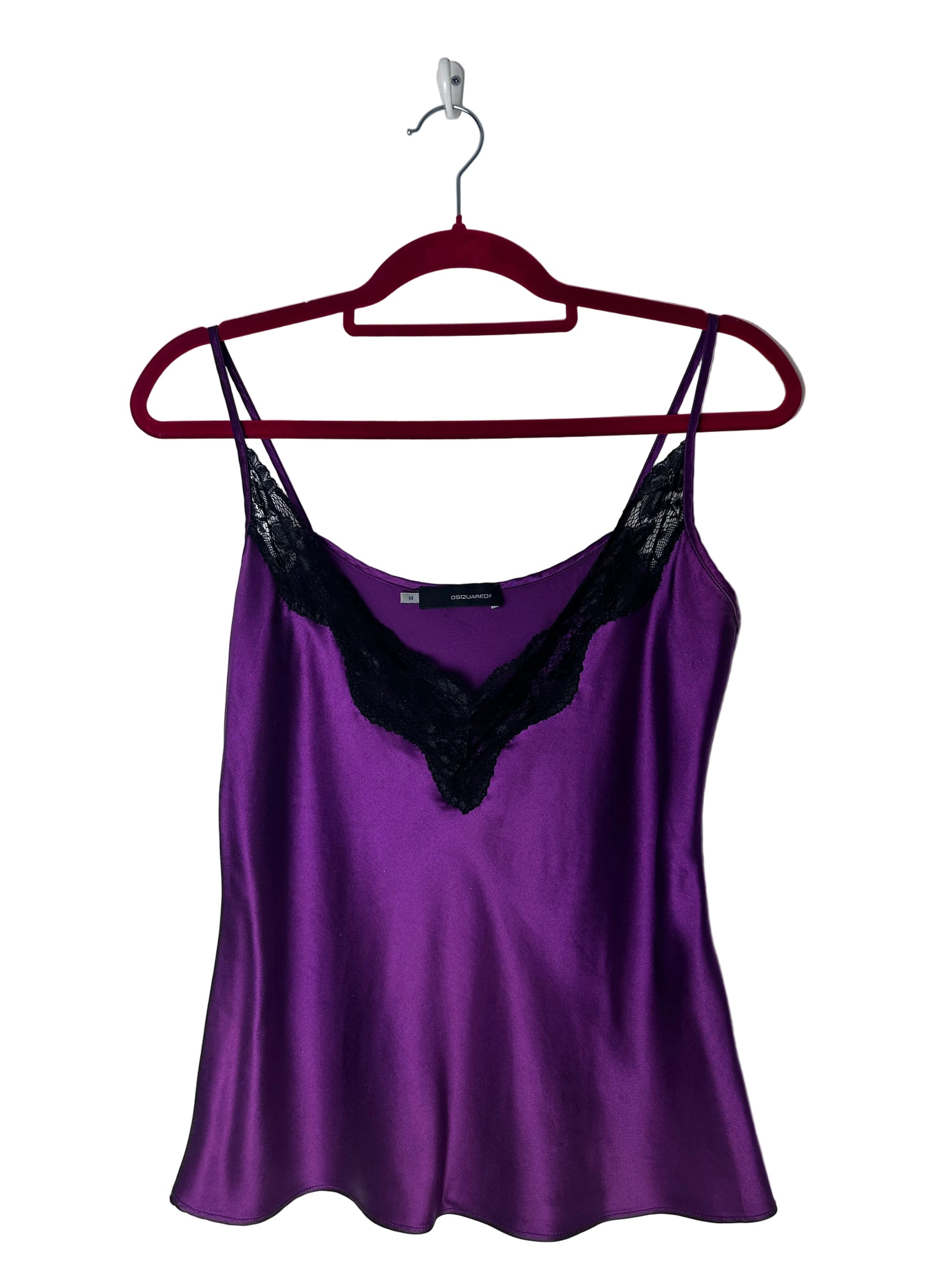 Purple top on a red hanger against a white background