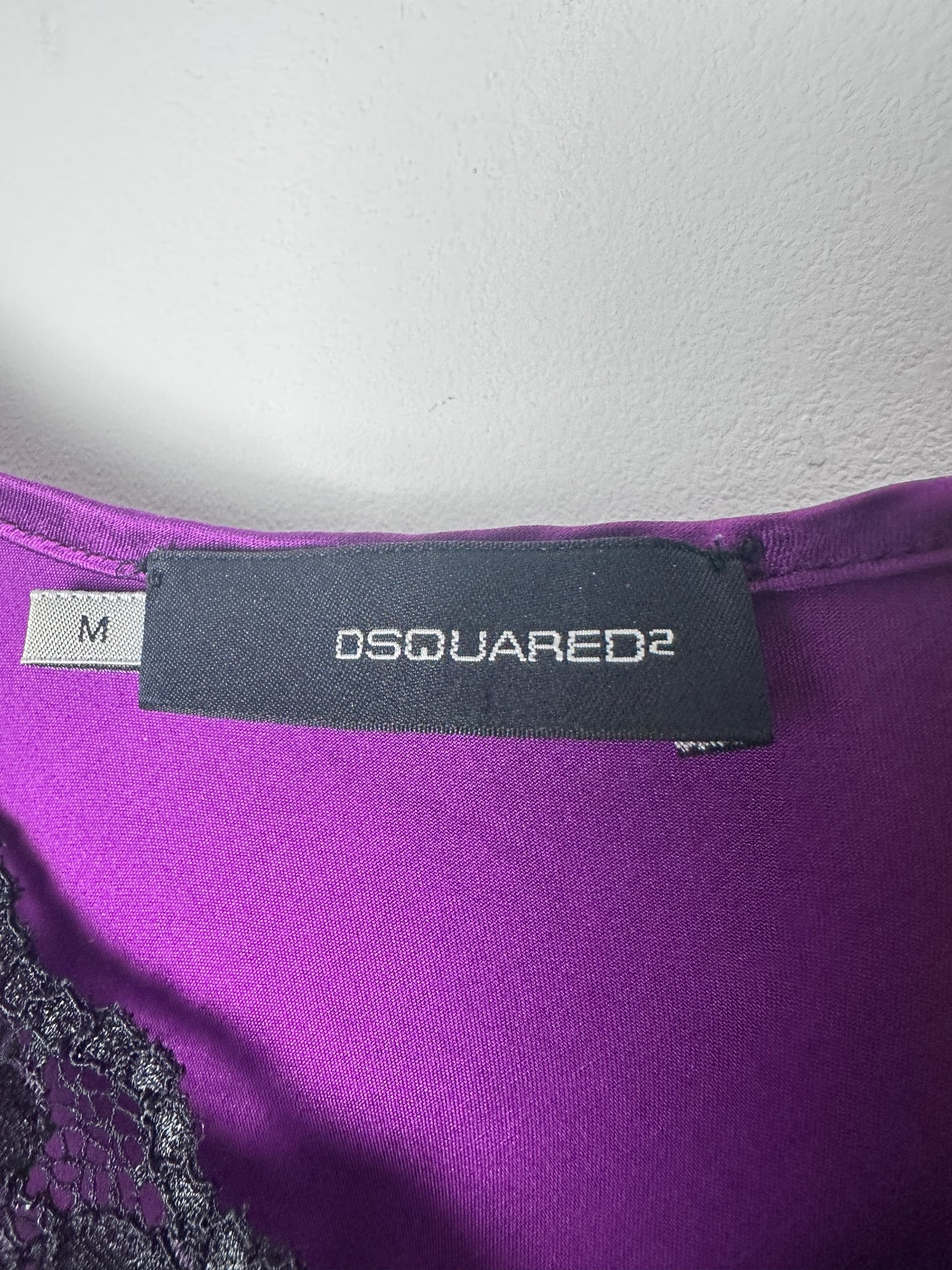 Purple garment with Dsquared2 label on a white background