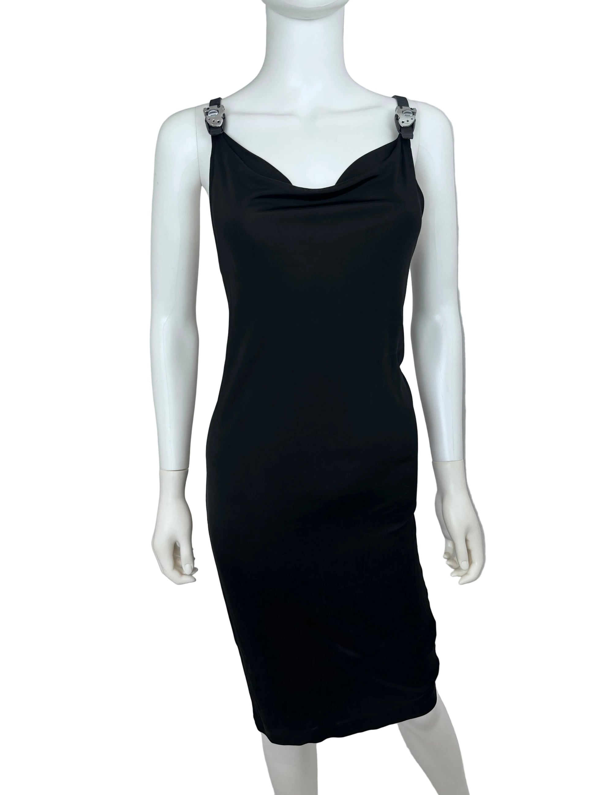 A black sleeveless bodycon dress displayed on a white mannequin torso, photographed indoors against a light gray wall and marble-patterned floor.
