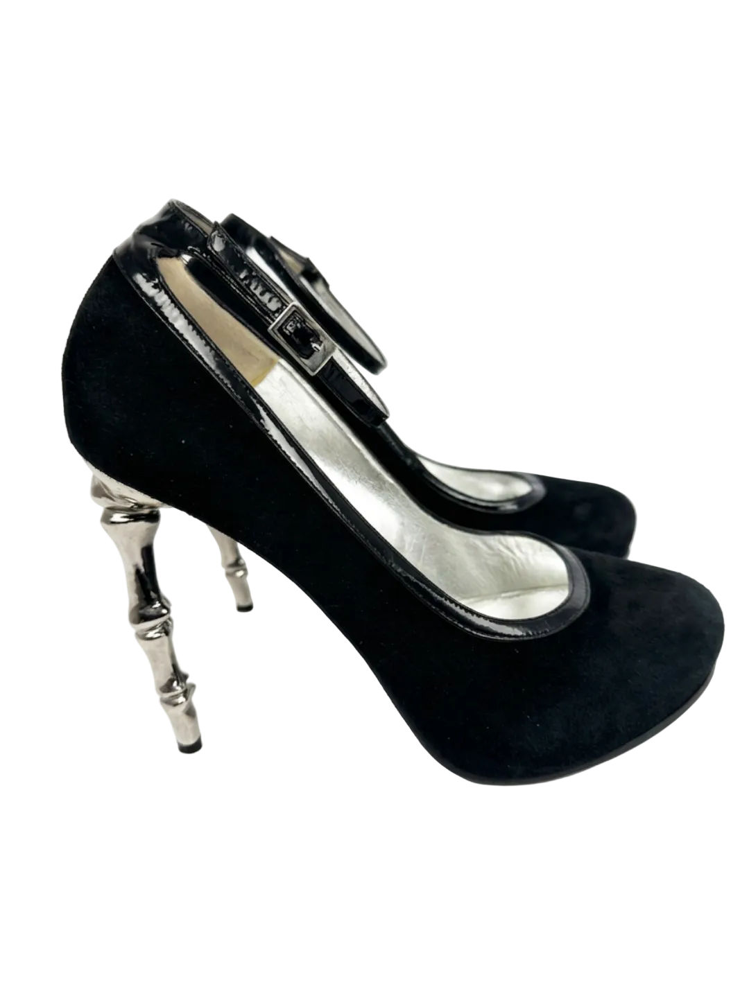 Black high-heeled shoes with silver metallic heels on a white background