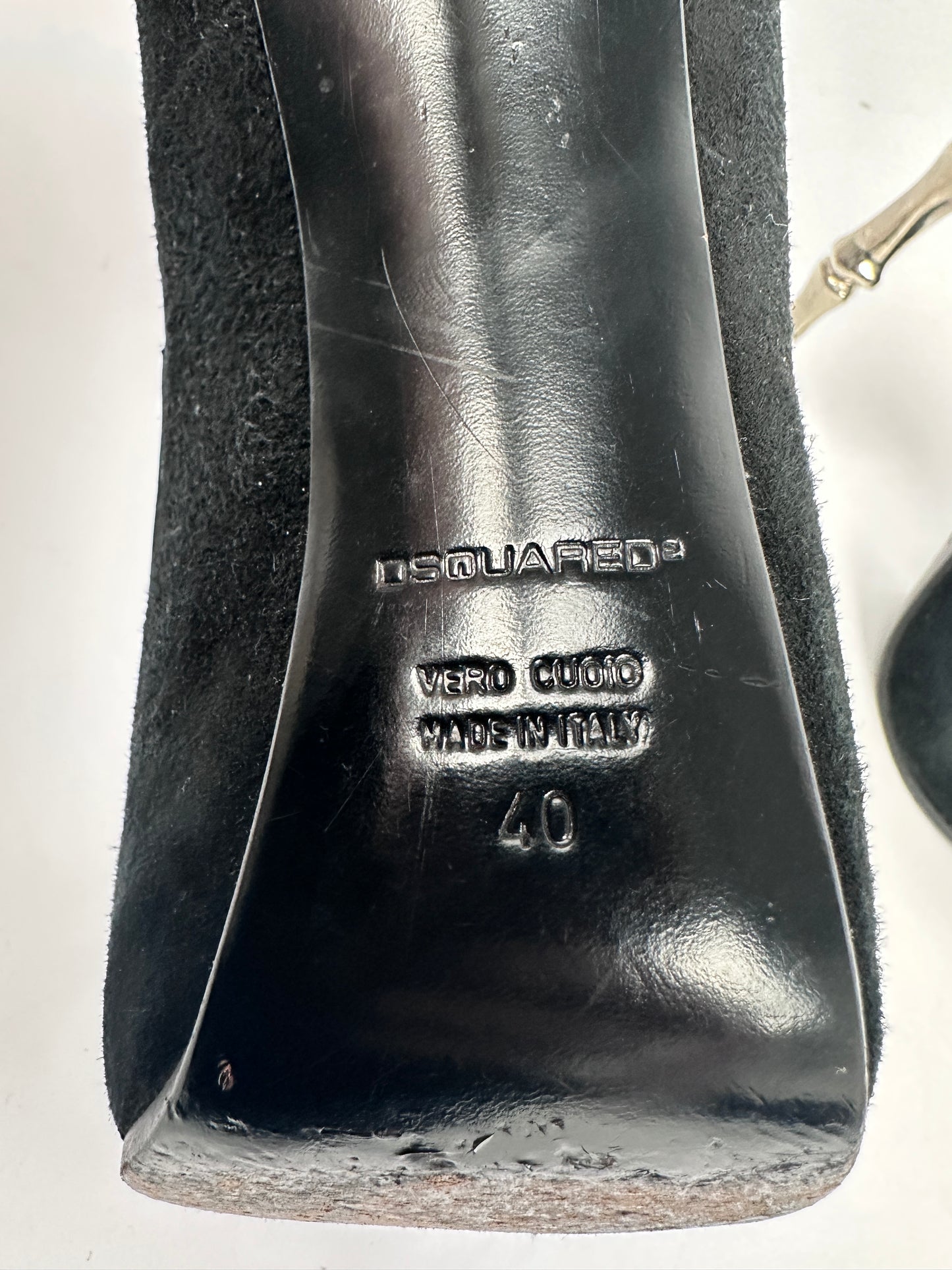 Black shoe with brand logo and size marking on a white background