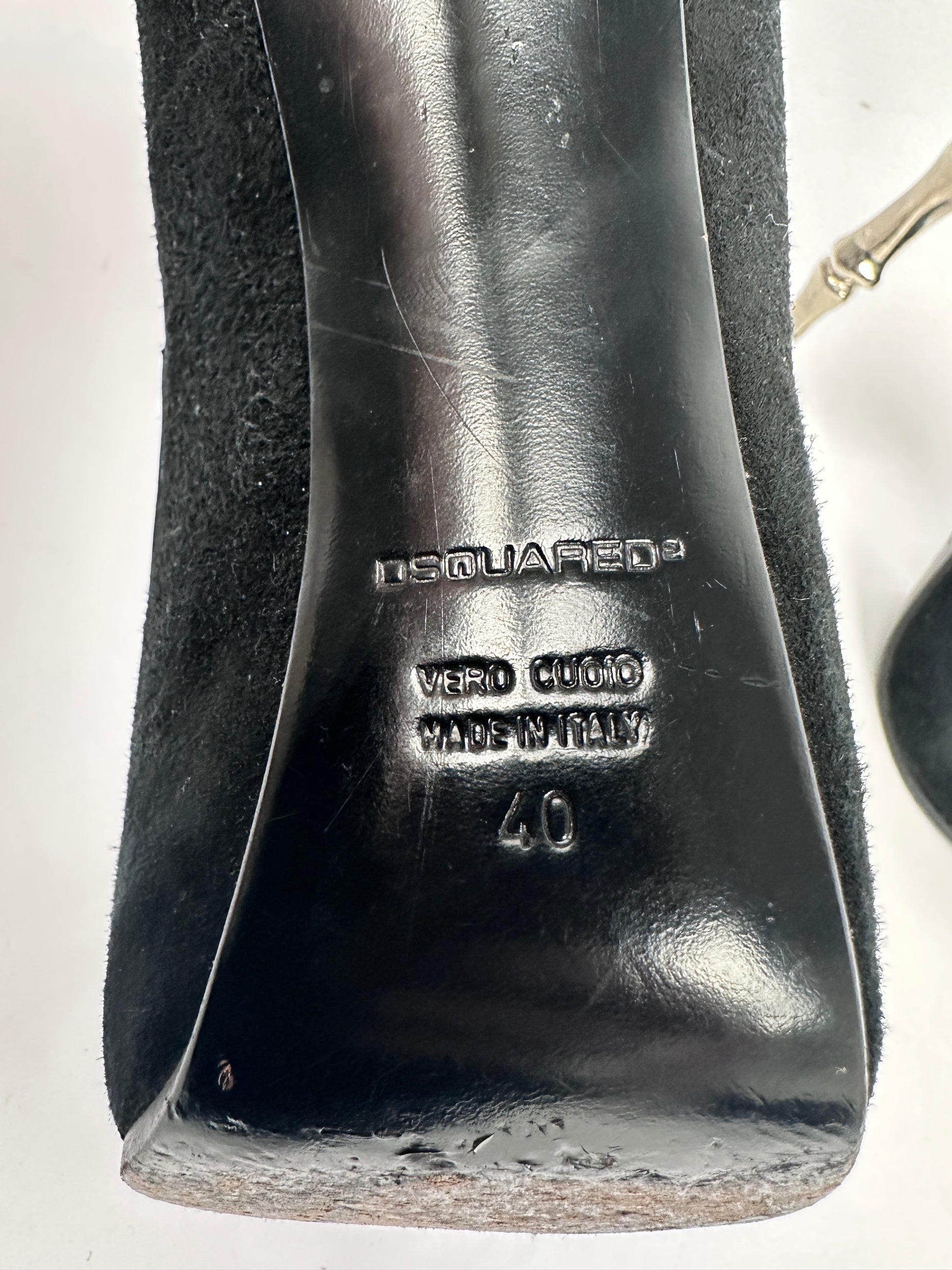 Black shoe with brand logo and size marking on a white background