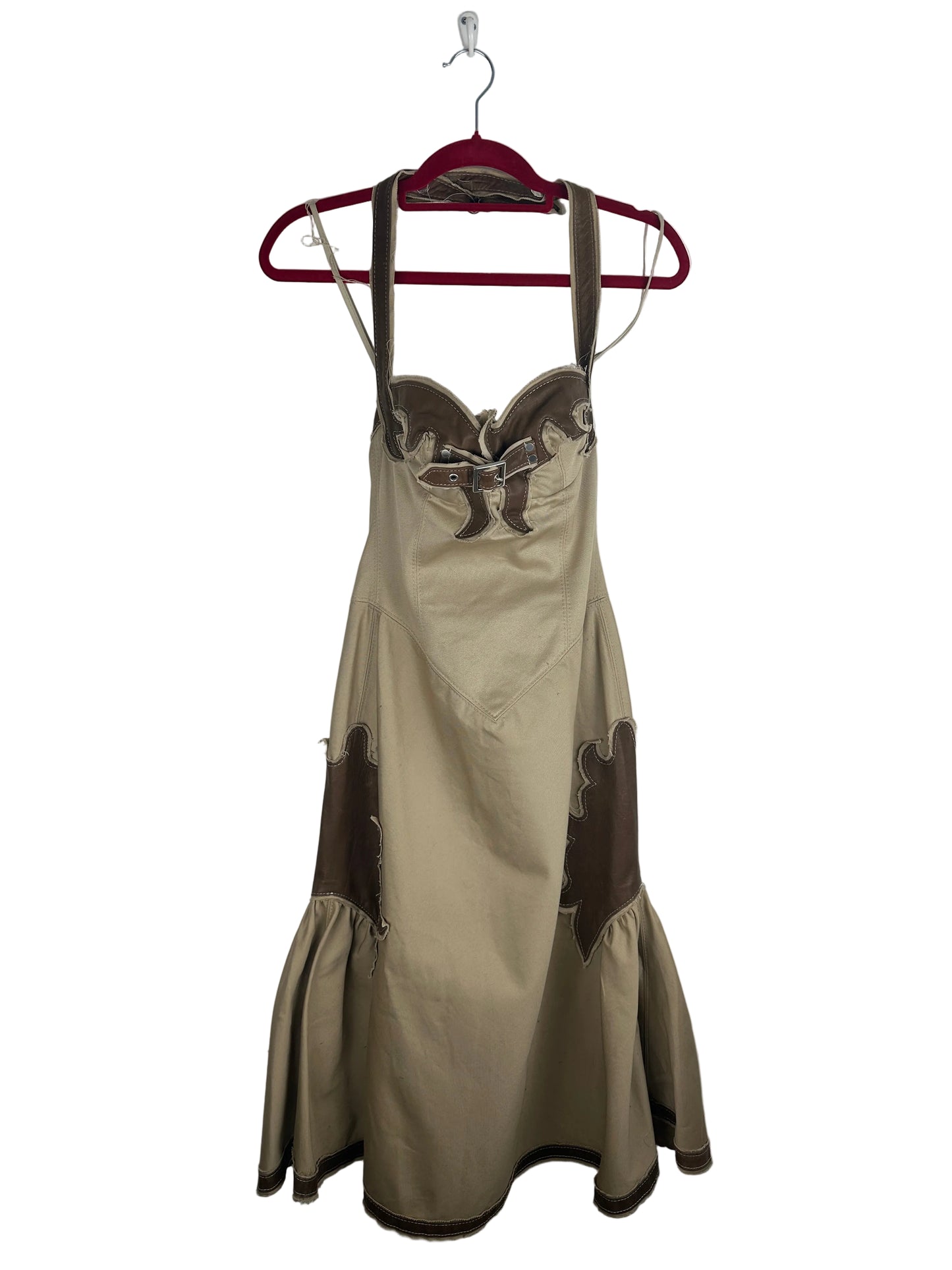 Beige dress with brown accents on a hanger against a white background