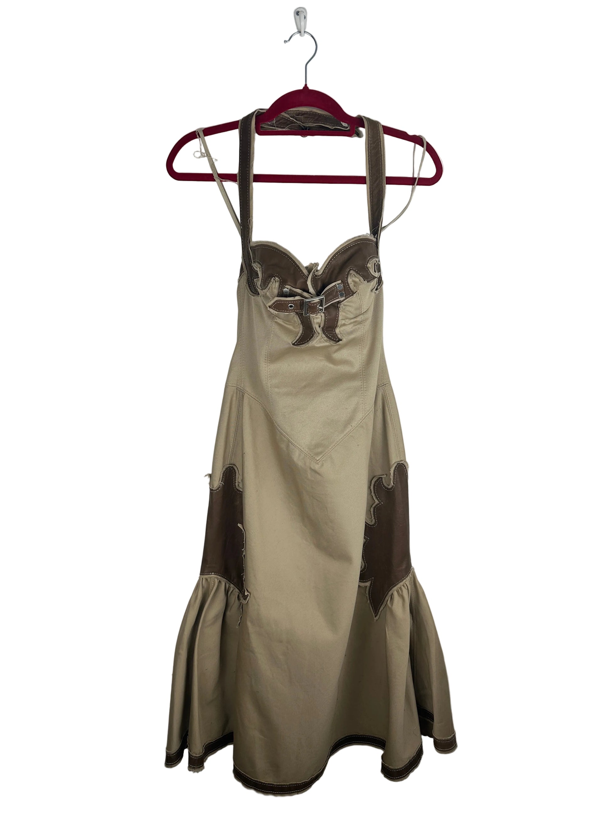 Beige dress with brown accents on a hanger against a white background
