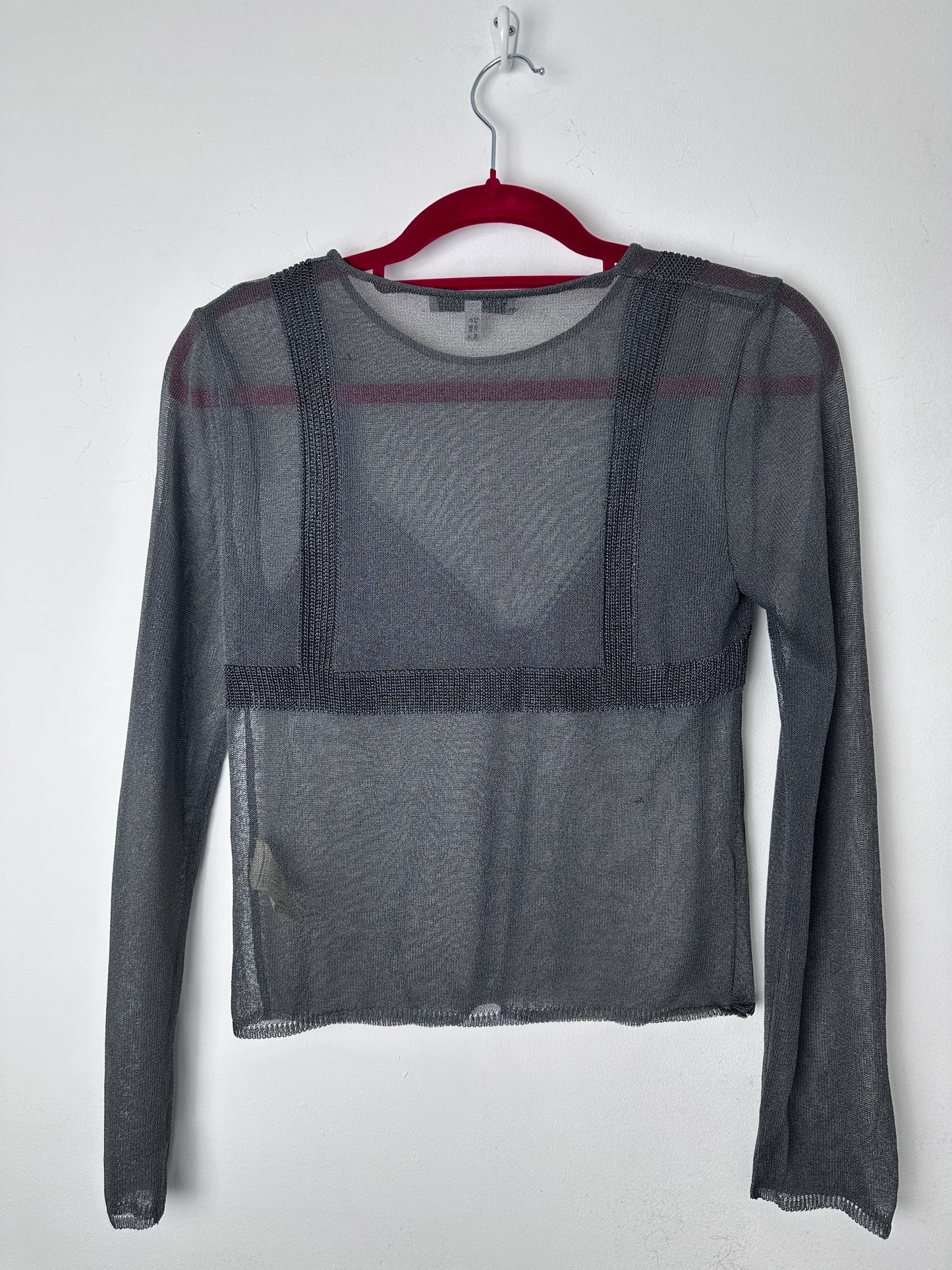 Gray mesh shirt on a hanger with a white background