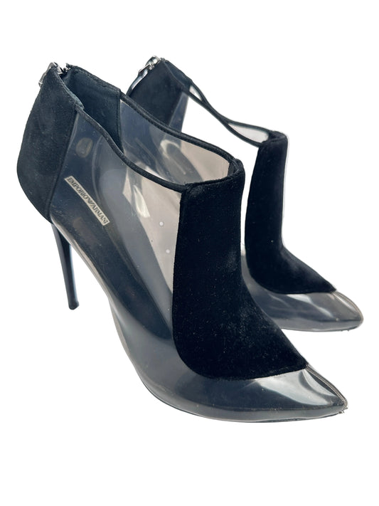Black high-heeled shoes with clear soles on a white background