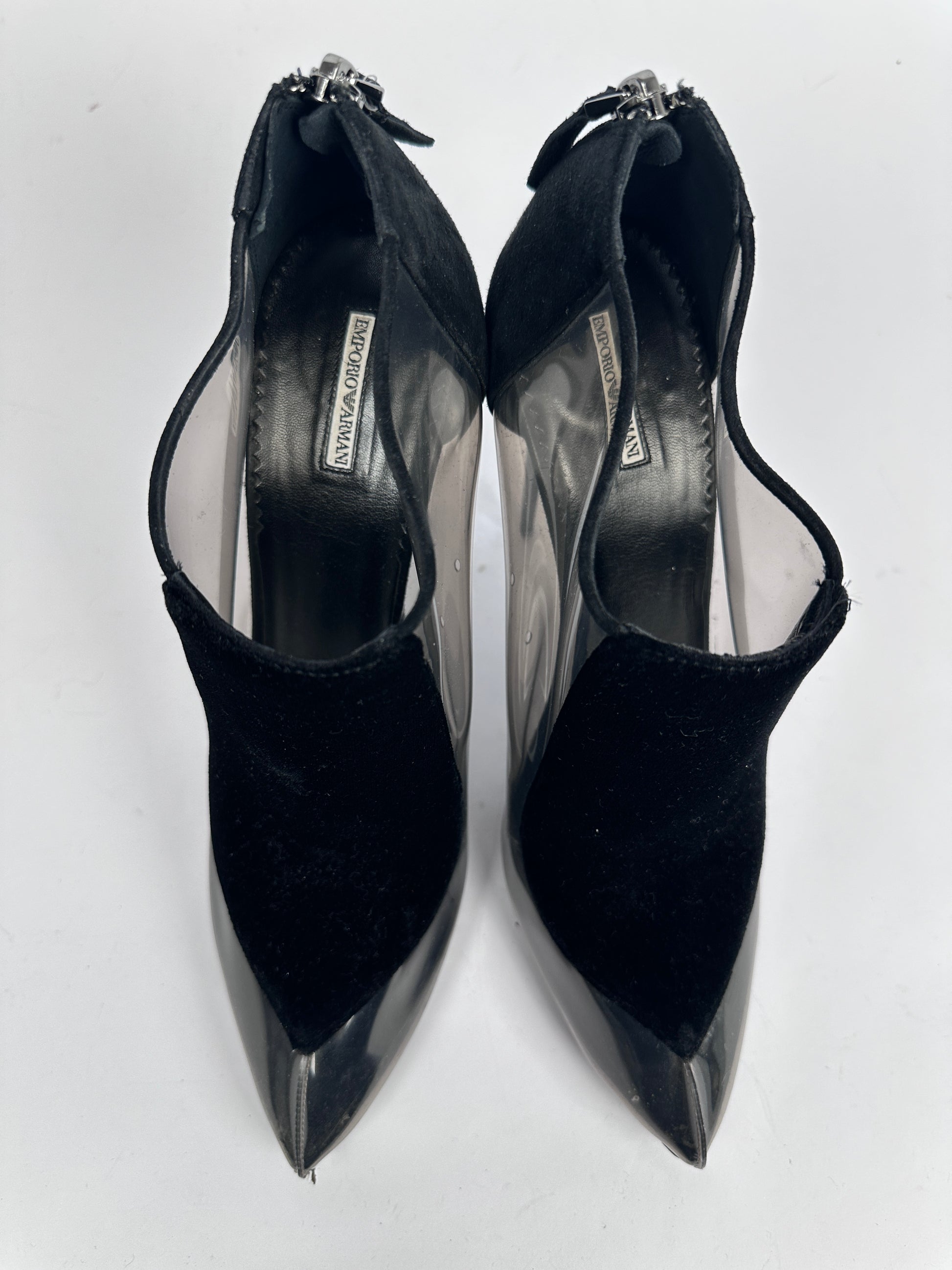 Black high-heeled shoes with a brand logo on a white background