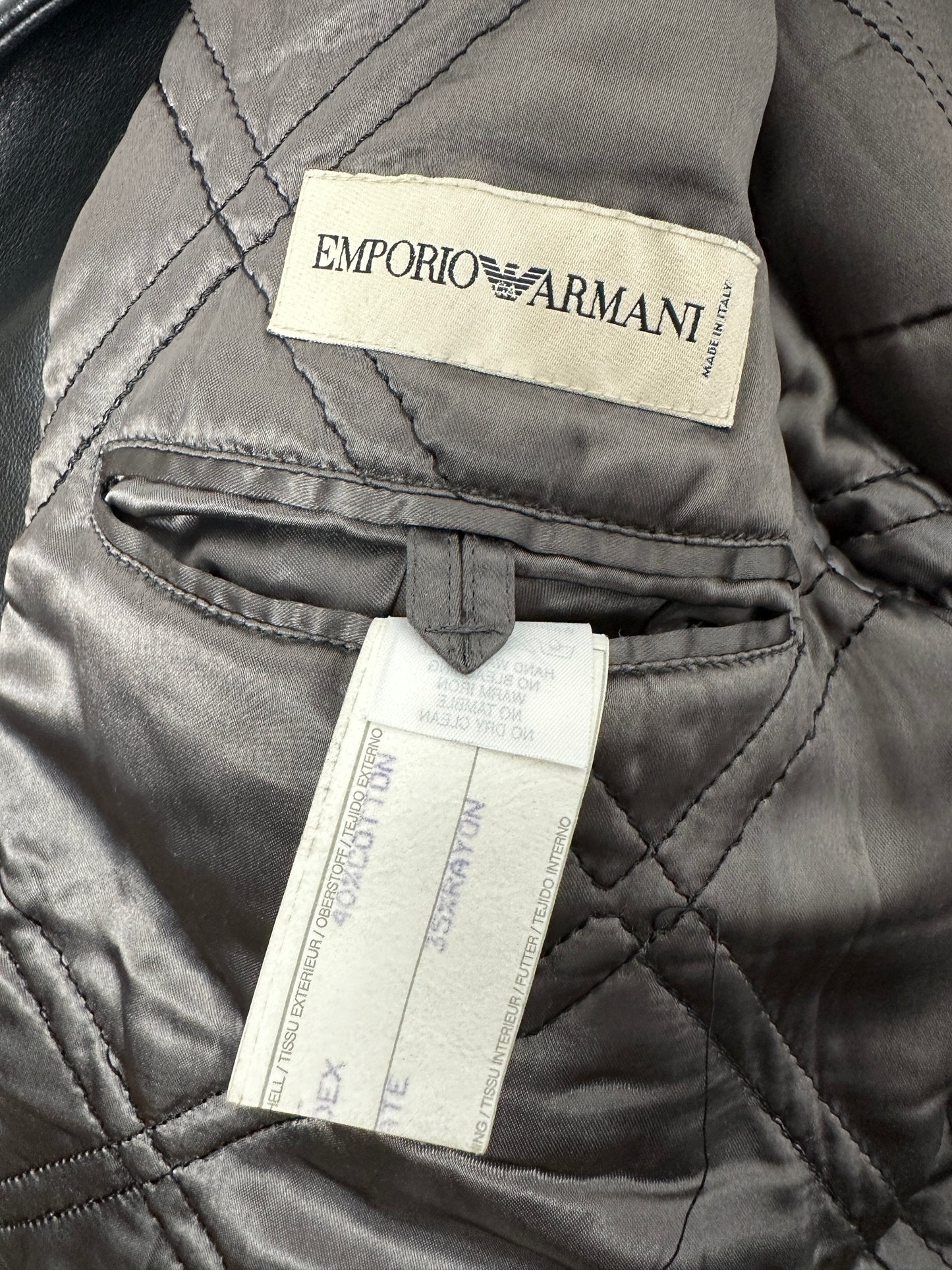 Close-up of a quilted jacket with Emporio Armani label and tag.