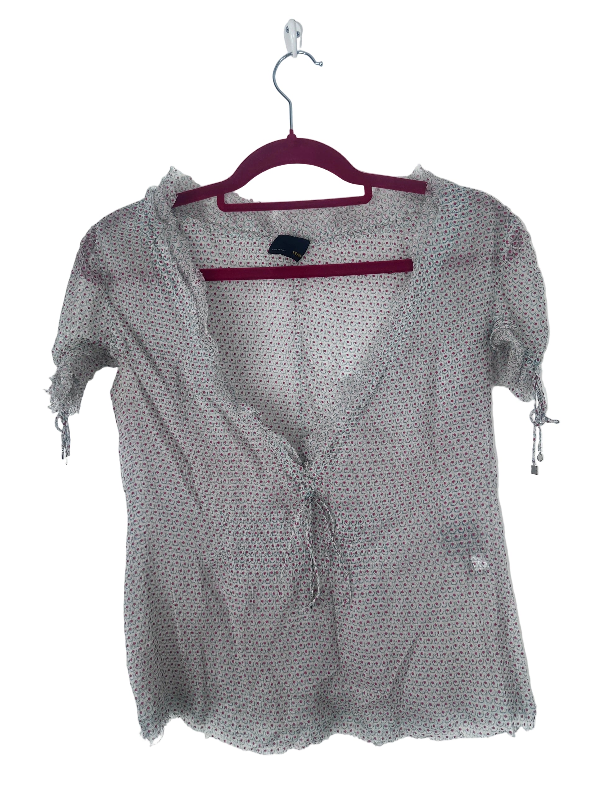 A sheer, lightweight gray mesh cardigan with a tiny white polka dot pattern, hanging on a dark red hanger against a plain white background.