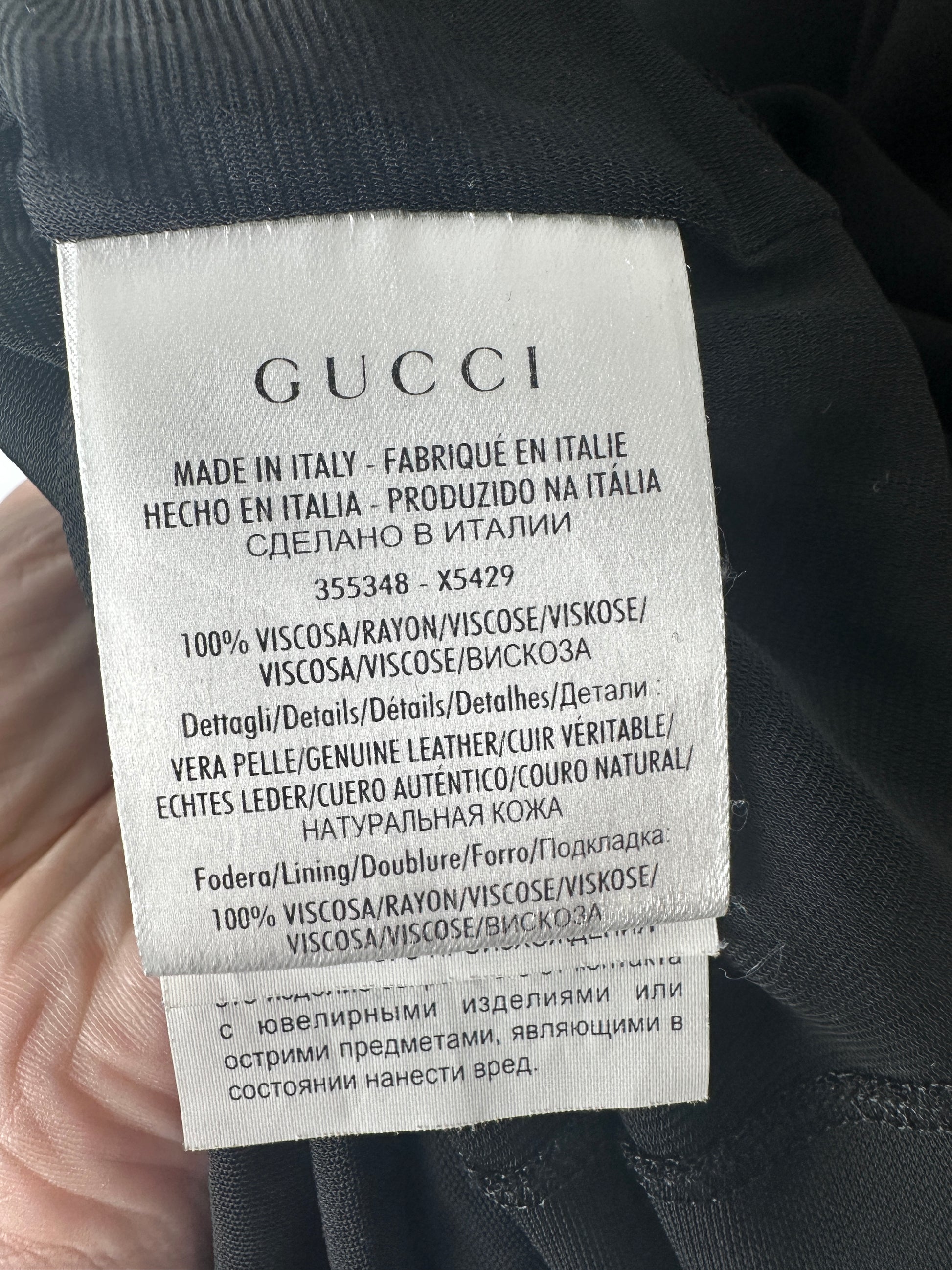Gucci label on a garment with text and product details.