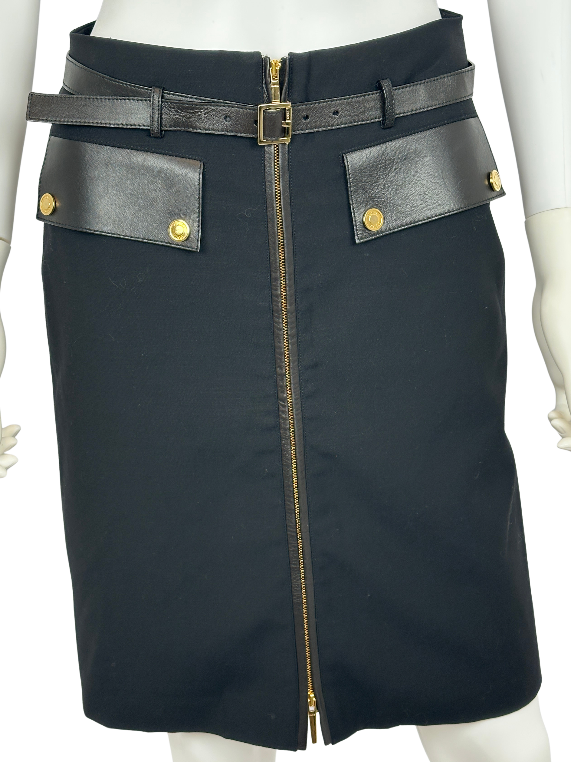 Black skirt with leather accents on a mannequin against a white background