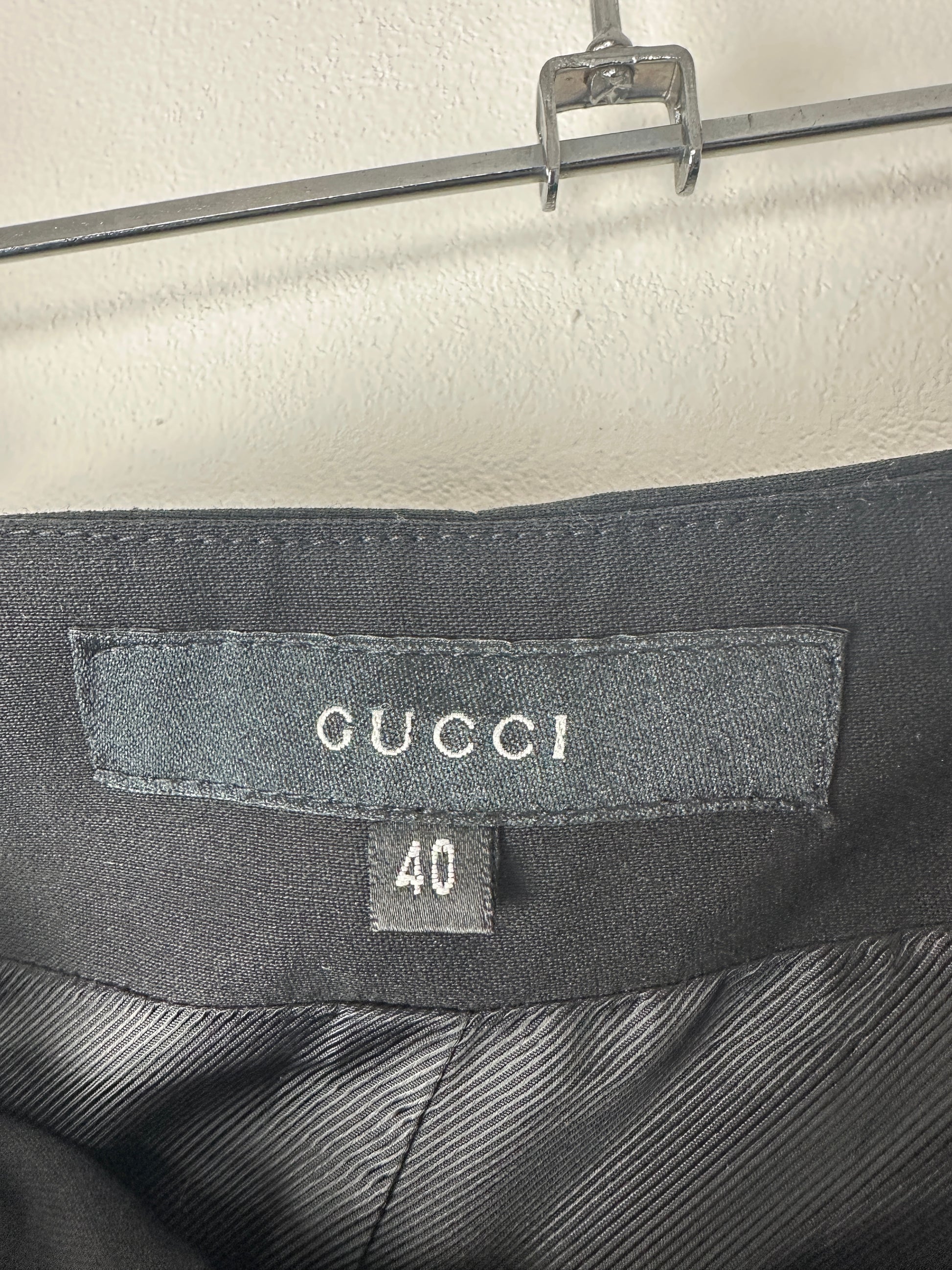 Gucci label on a garment with size 40 against a neutral background