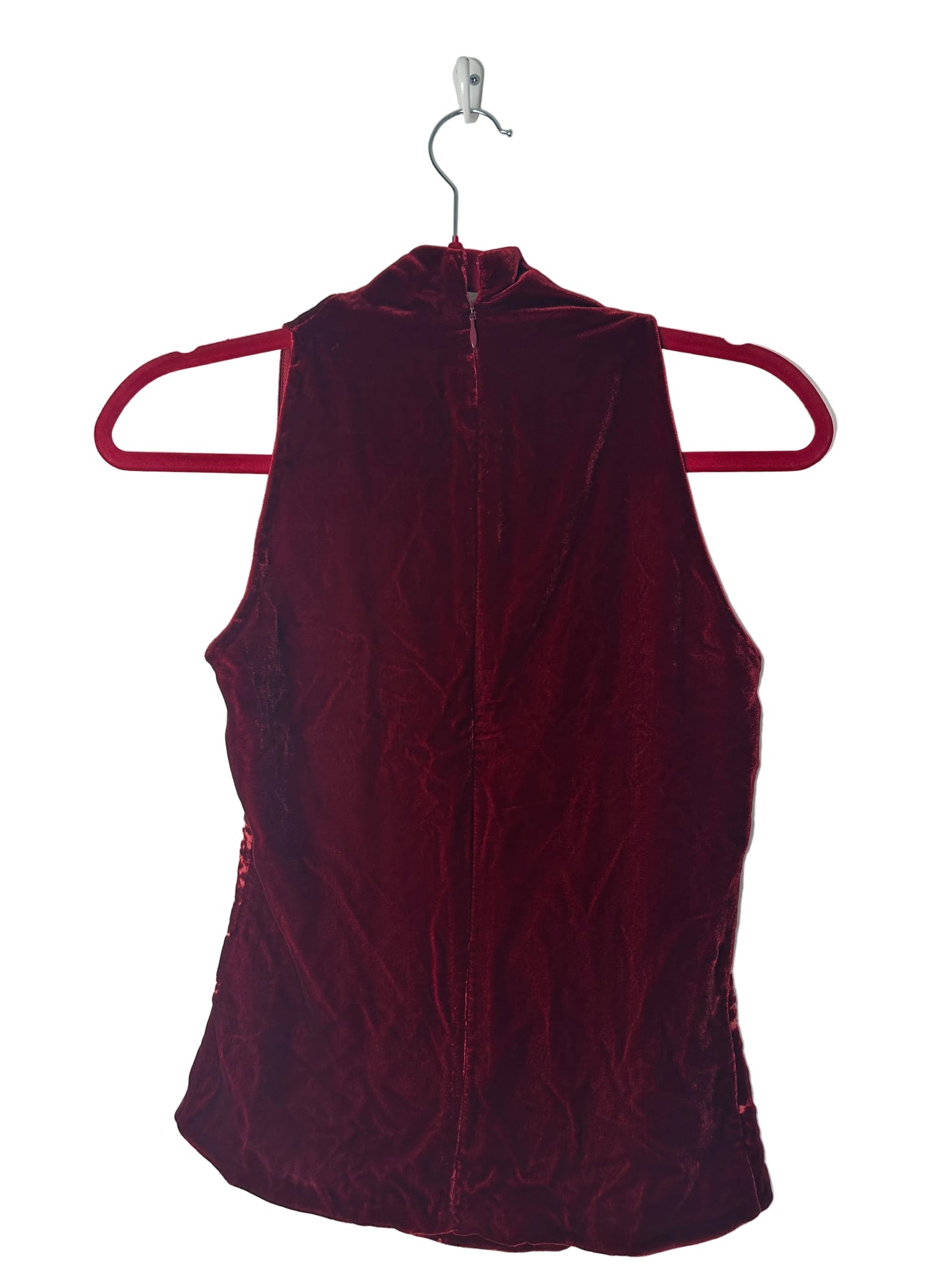 Maroon velvet dress on a hanger against a white background