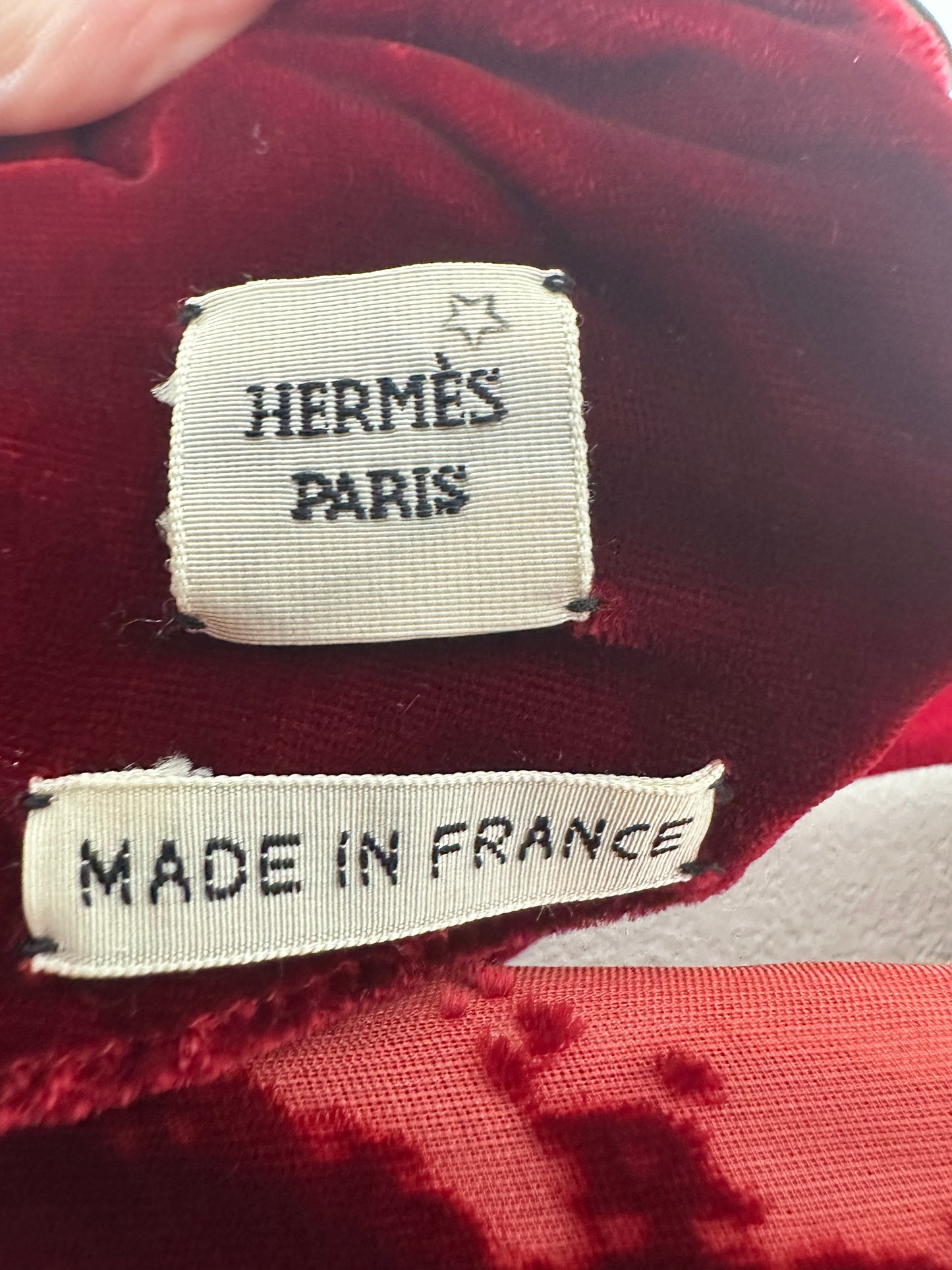 Hermes Paris label on a red fabric background