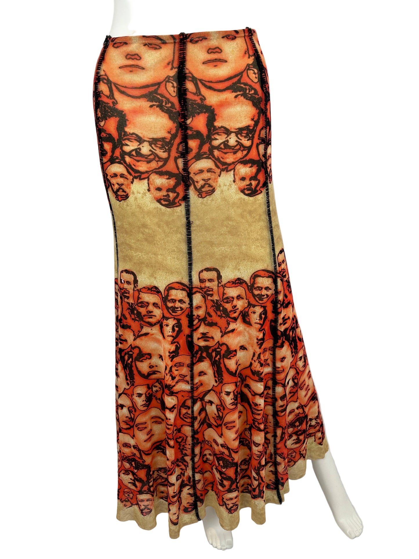Decorative skirt with a pattern of small faces on a white background
