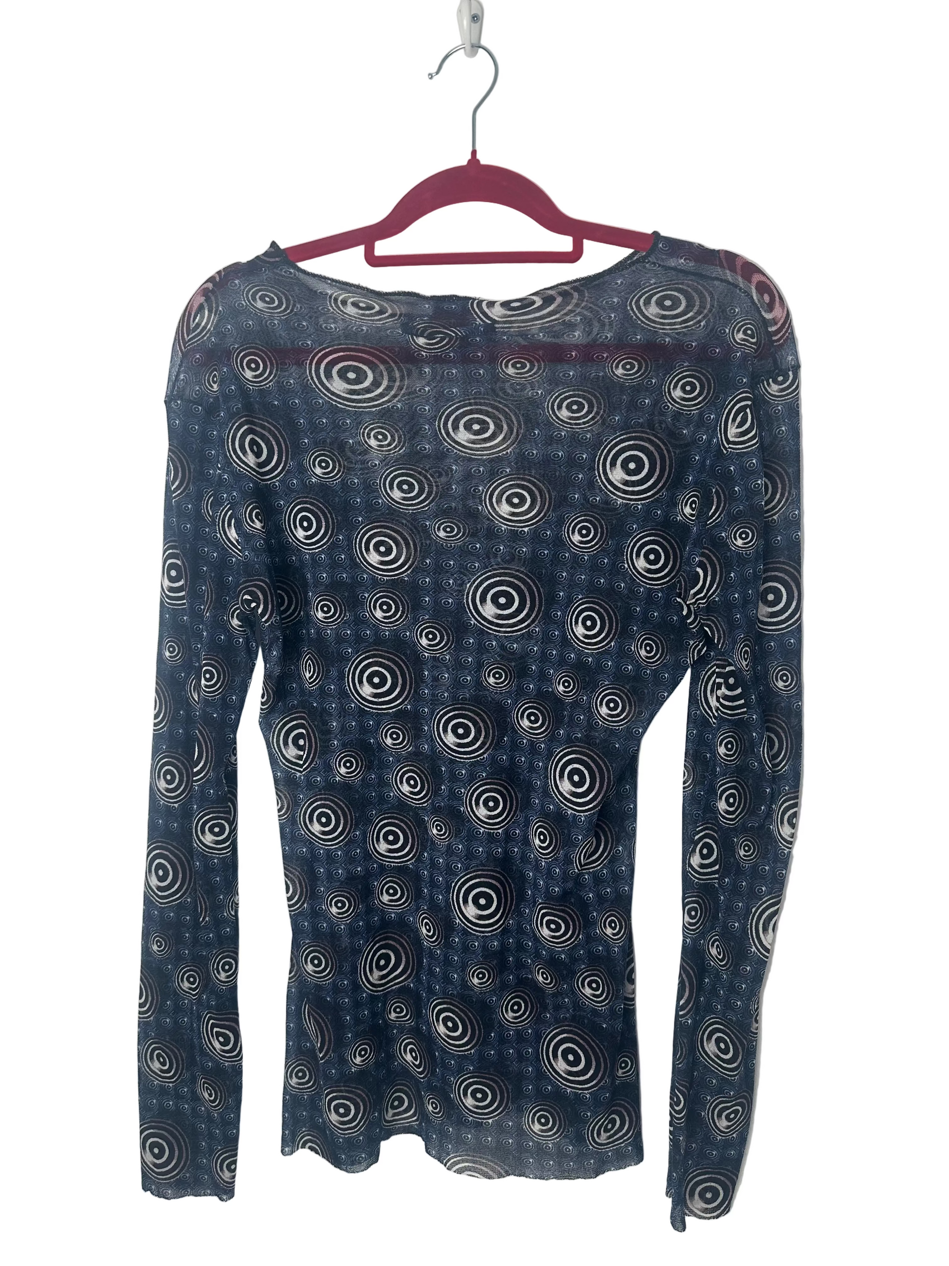 Blue long-sleeve top with circular pattern on a hanger against a white background