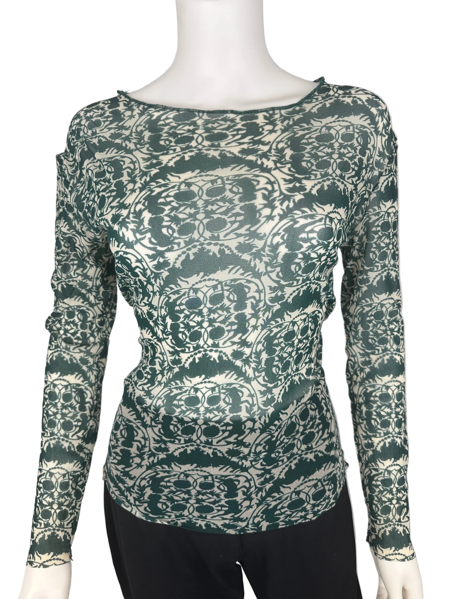 Green patterned top on a mannequin against a white background