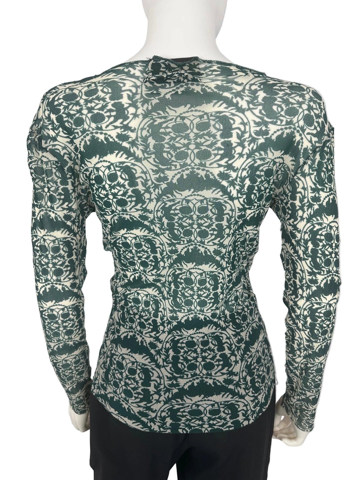 Green patterned top on a white background