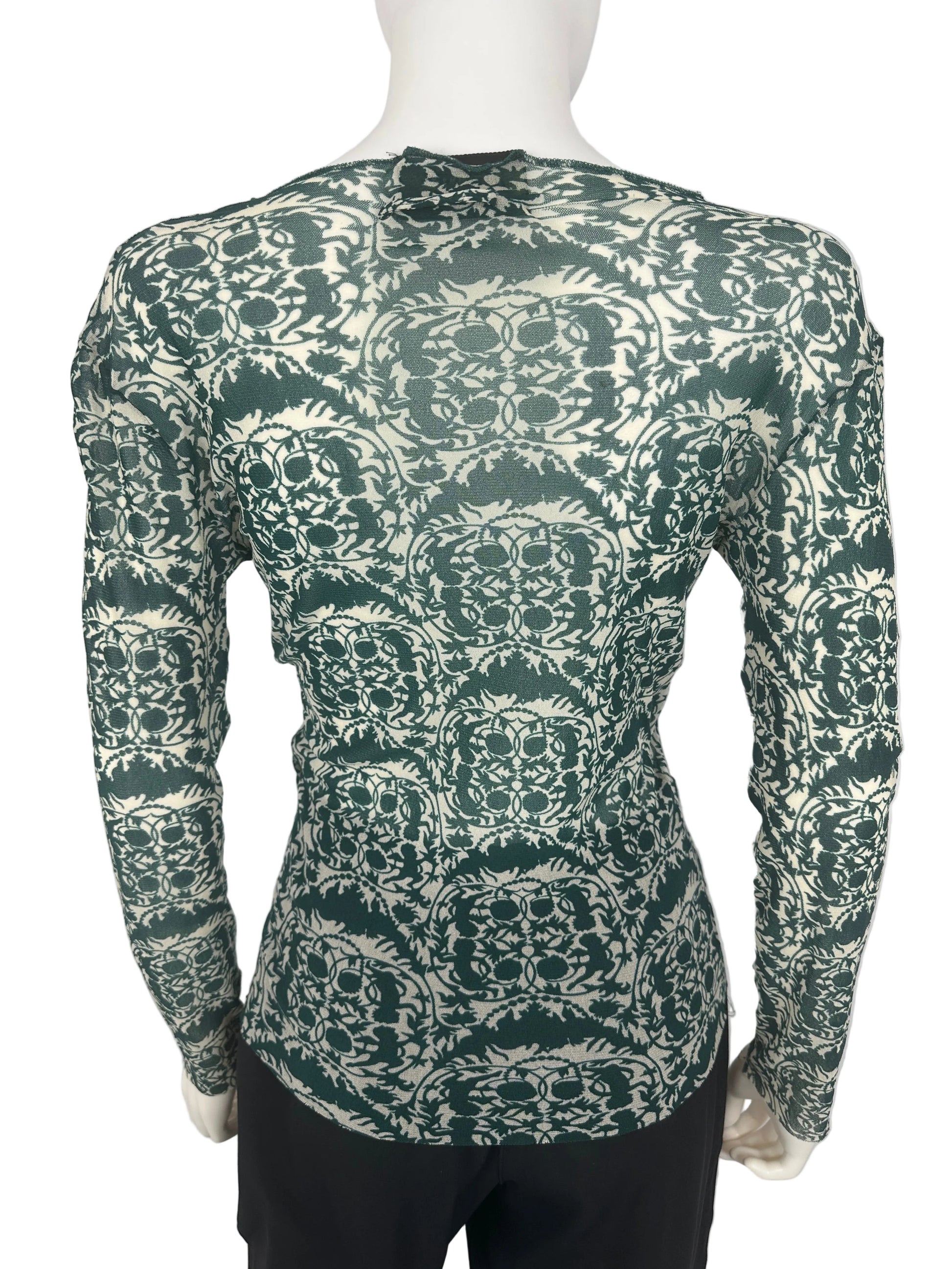 Green patterned top on a white background