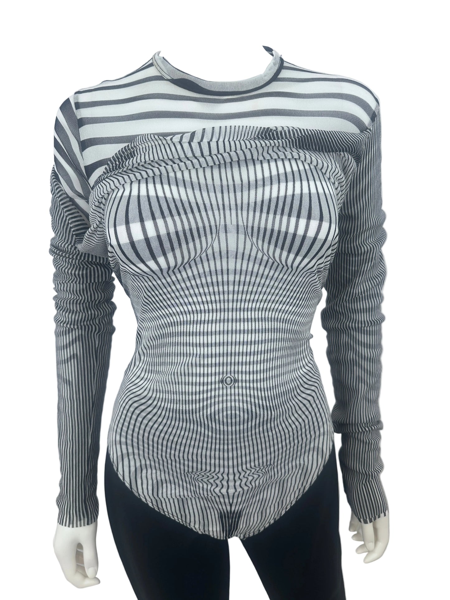 A long-sleeve ribbed knit top with a black and white wavy stripe pattern, displayed on a mannequin torso against a plain white wall.